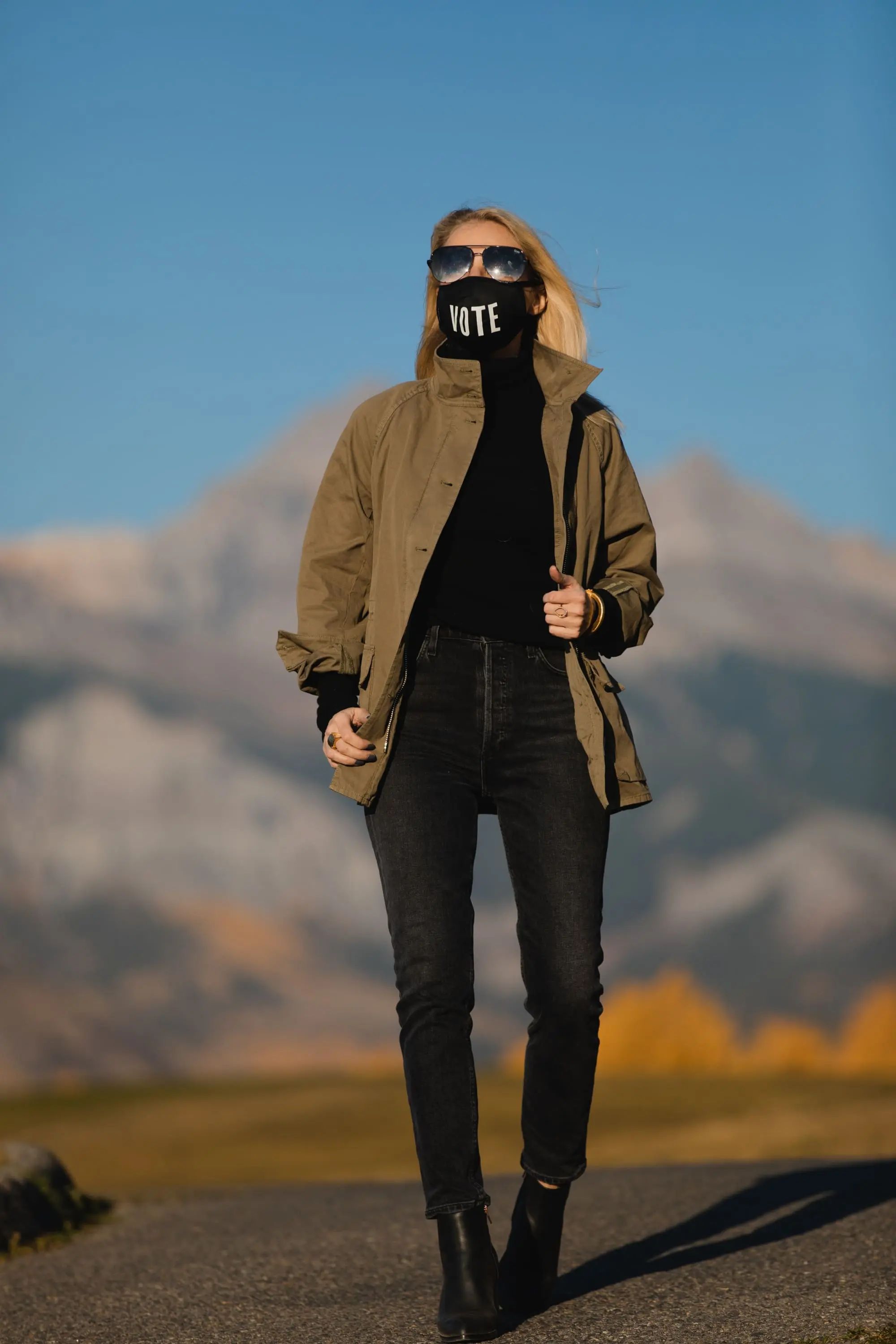 How To Wear A Cargo Jacket, Erin Busbee of Busbee Style wearing a green cargo jacket by rag & bone, black turtleneck puff sleeve cashmere sweater by Aqua, gray wash Nico slim fit jeans by Agolde, QUAY sunglasses, Vote mask, and Alexander Wang cutout booties from Bloomingdale's in Telluride, Colorado