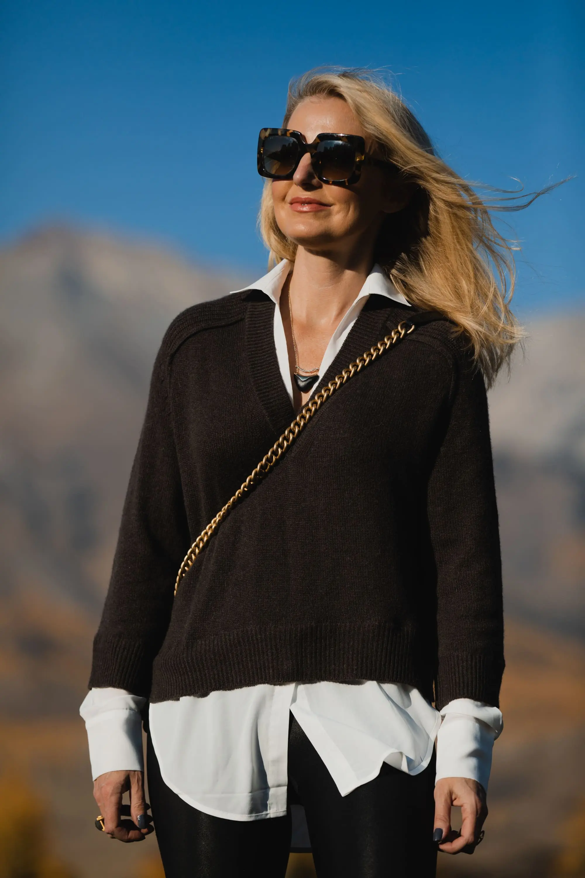 Layered Sweater, Erin Busbee of Busbee Style wearing a brown layered sweater by Brochu Walker, Spanx faux leather leggings, See by Chloe combat boots, and black Chanel boy bag in Telluride, Colorado