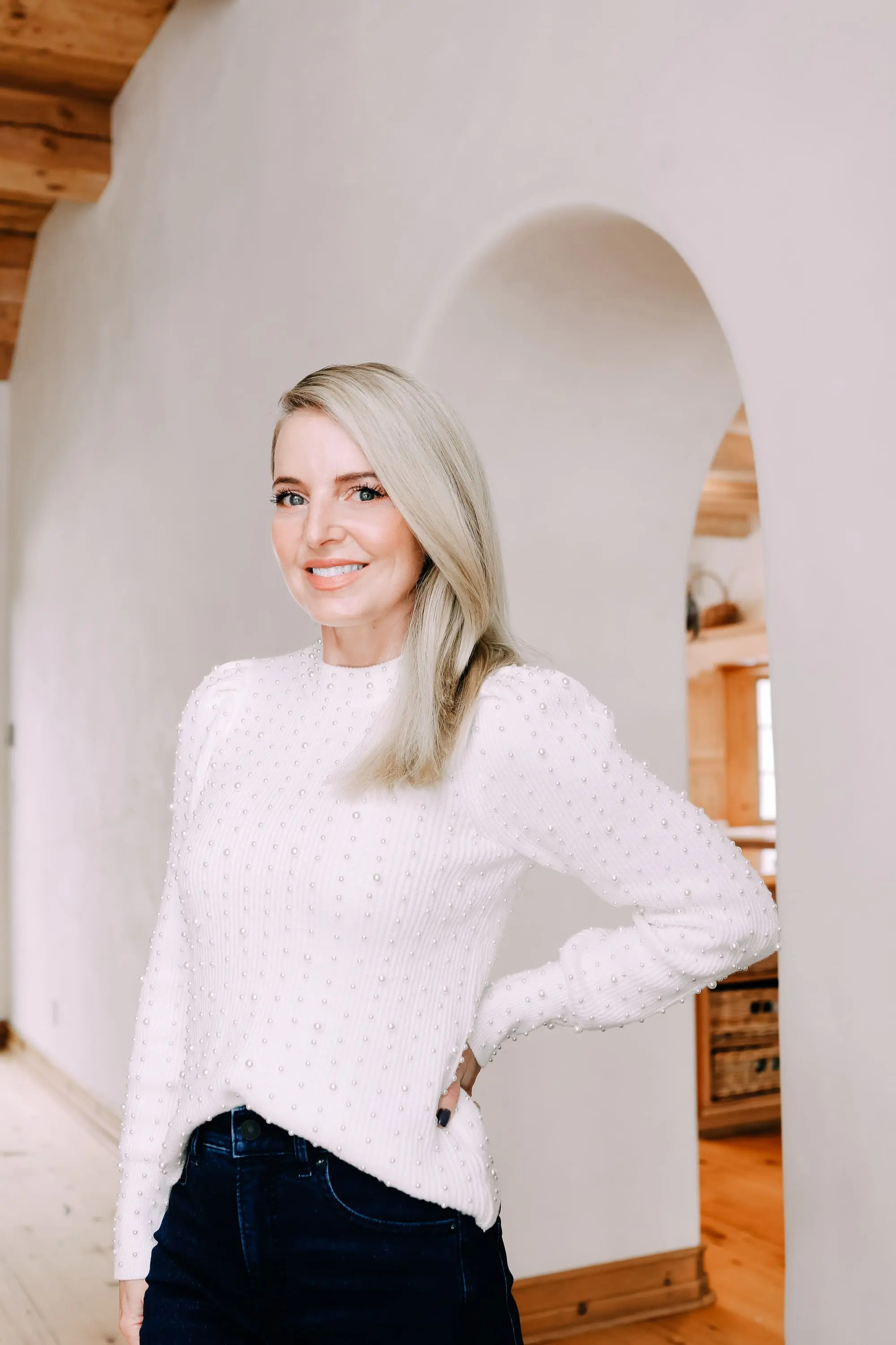 Cozy Sweaters, Black Friday Doorbuster, Erin Busbee of Busbee Style wearing a metallic blouson sleeve turtleneck sweater, raw step hem jeans, and cozy socks from Express in Telluride, Colorado
