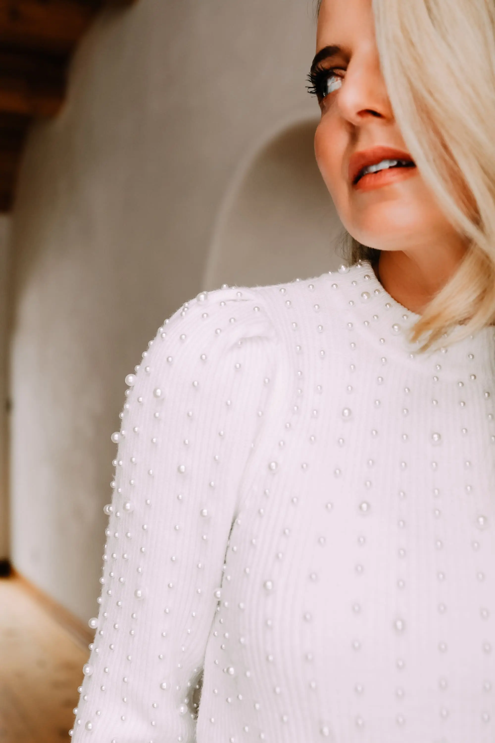 Black Friday Doorbuster, Erin Busbee of Busbee Style wearing a pearl embellished white sweater, raw step hem jeans, and cozy socks from Express in Telluride, Colorado
