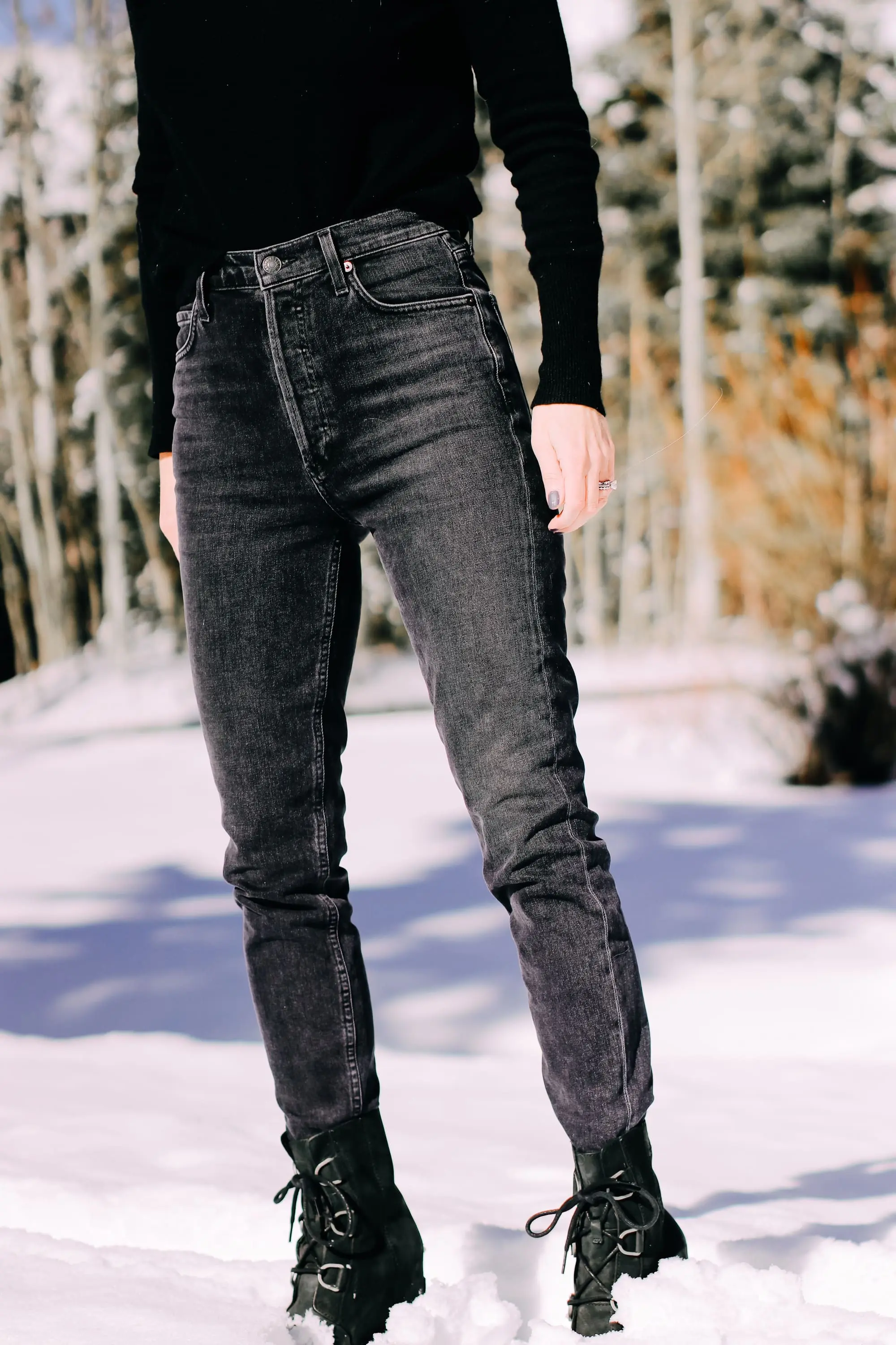 Thoughtful Gifts, Erin Busbee of Busbee Style wearing a black puff sleeve cashmere sweater by AQUA, gray wash Agolde jeans, black Sorel boots, and a diamond star necklace by Marc & Marcella from Bloomingdale's in Telluride, Colorado