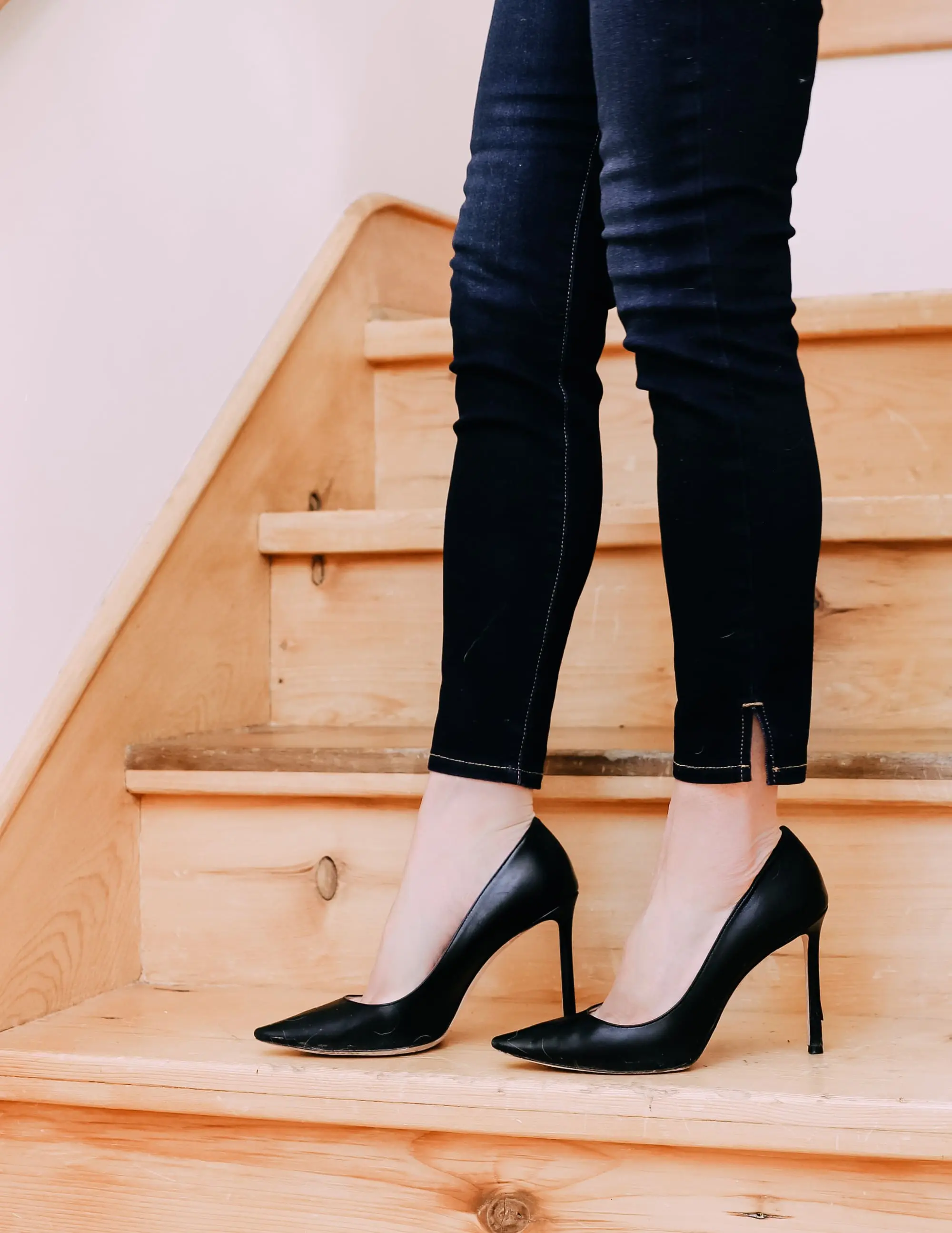 Holiday Outfits With Jeans, Erin Busbee of Busbee Style wearing a black lace corset top by Jonathan Simkhai, L'Agence dark wash skinny jeans, and black Jimmy Choo Romy pumps from Nordstrom in Telluride, Colorado
