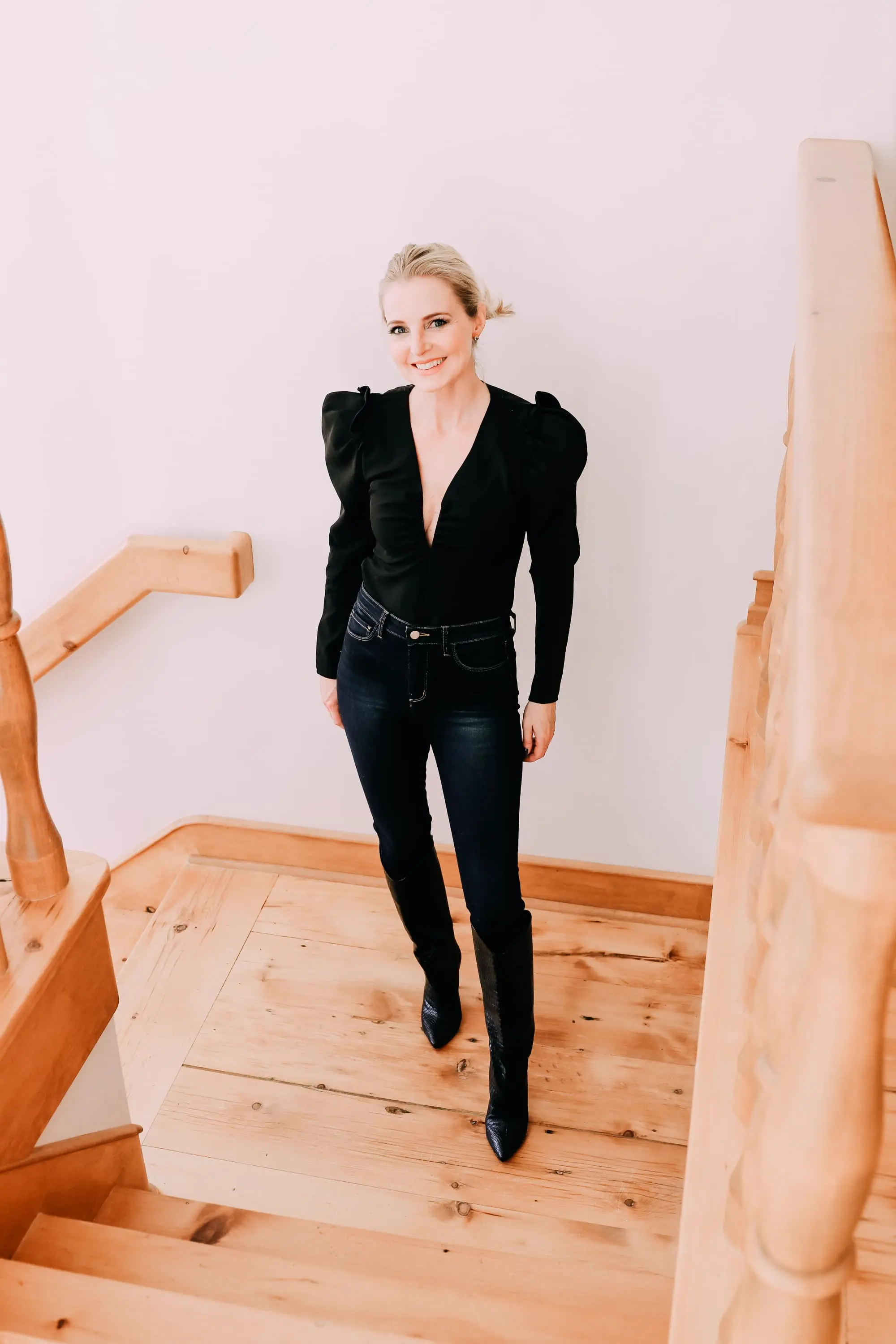 Holiday Outfits With Jeans, Erin Busbee of Busbee Style wearing a black ASTR the Label puff sleeve bodysuit, L'Agence dark wash skinny jeans, and black snake embossed boots by Schutz from Nordstrom in Telluride, Colorado