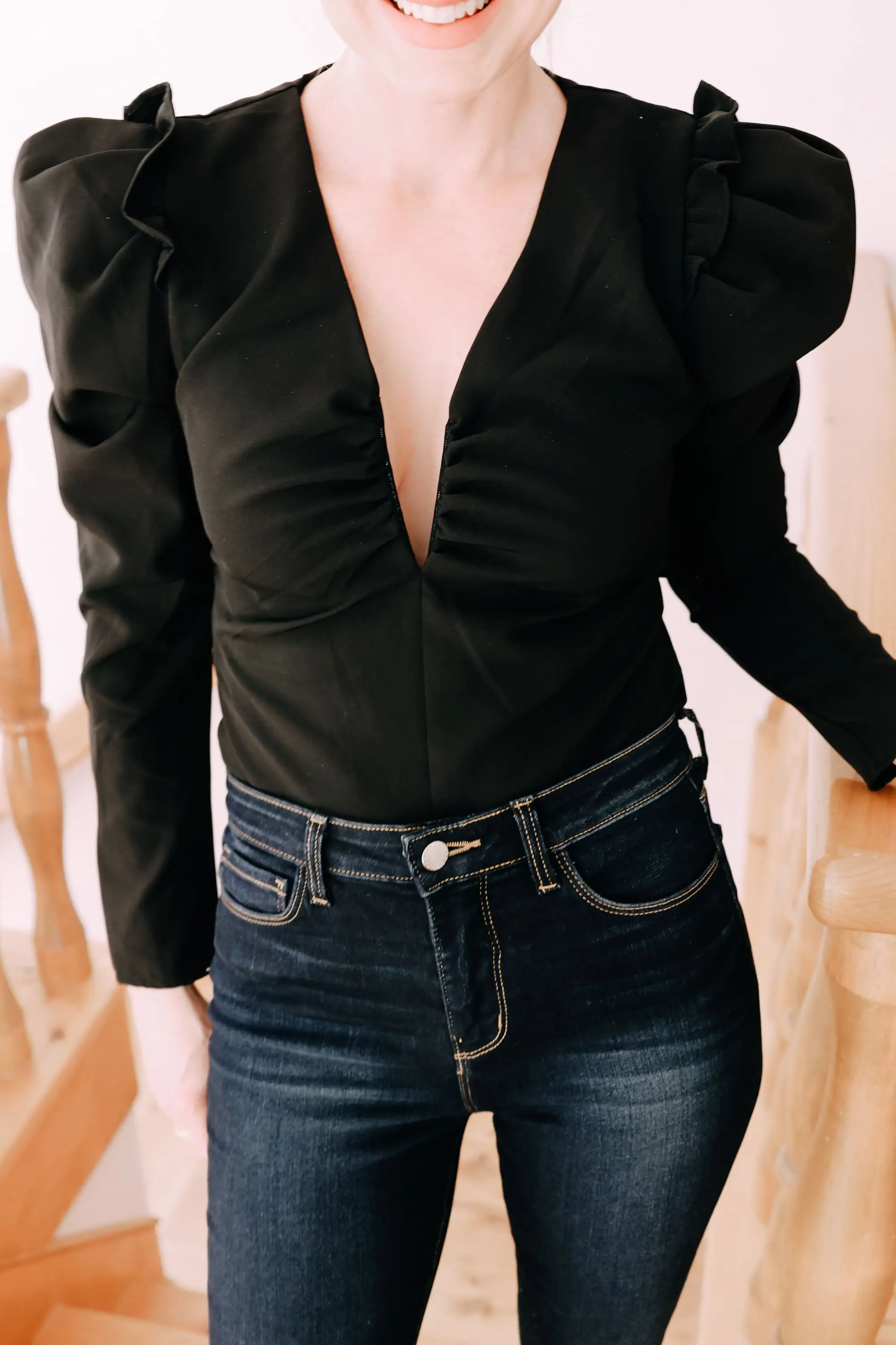 Holiday Outfits With Jeans, Erin Busbee of Busbee Style wearing a black ASTR the Label puff sleeve bodysuit, L'Agence dark wash skinny jeans, and black snake embossed boots by Schutz from Nordstrom in Telluride, Colorado