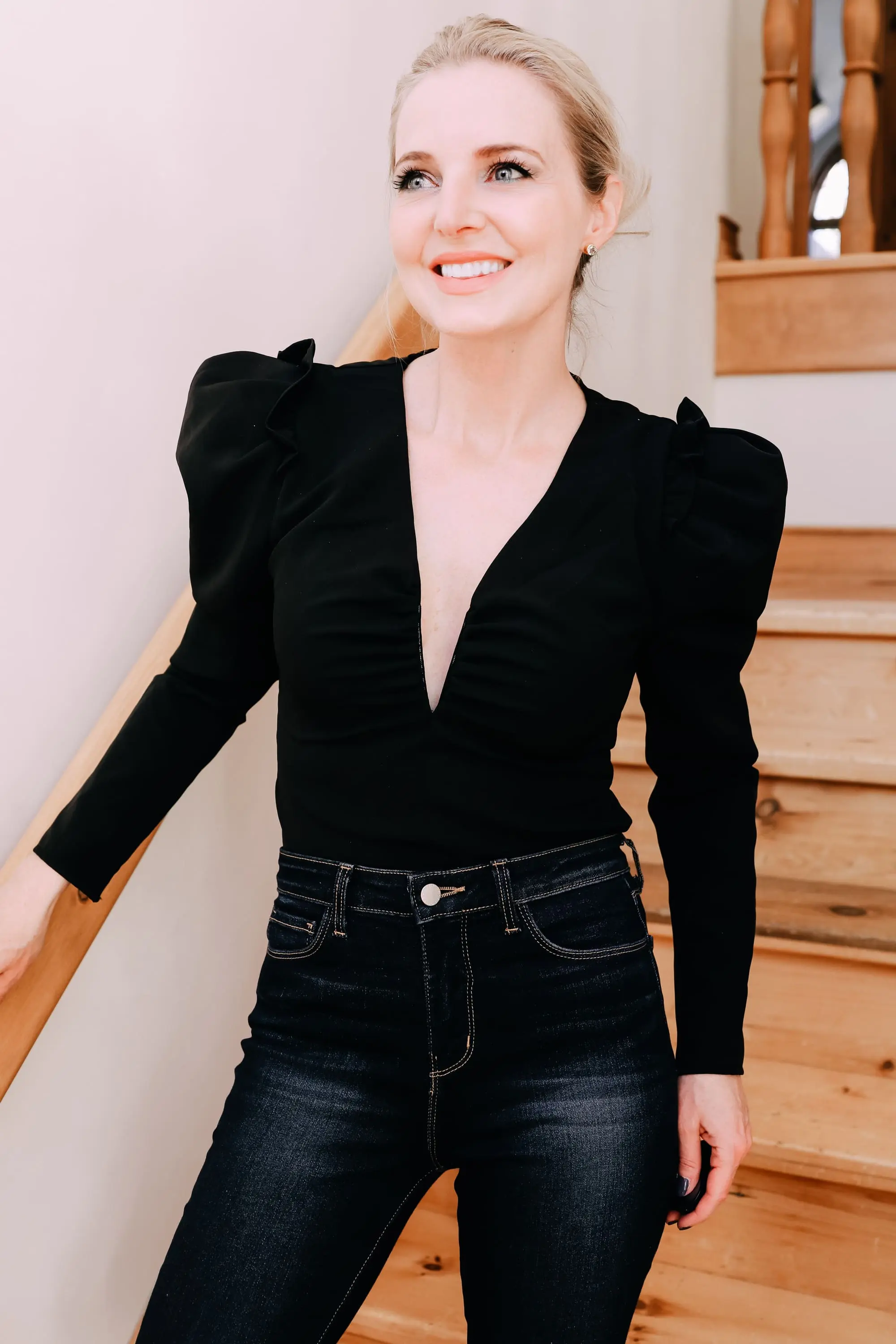 Holiday Outfits With Jeans, Erin Busbee of Busbee Style wearing a black ASTR the Label puff sleeve bodysuit, L'Agence dark wash skinny jeans, and black snake embossed boots by Schutz from Nordstrom in Telluride, Colorado