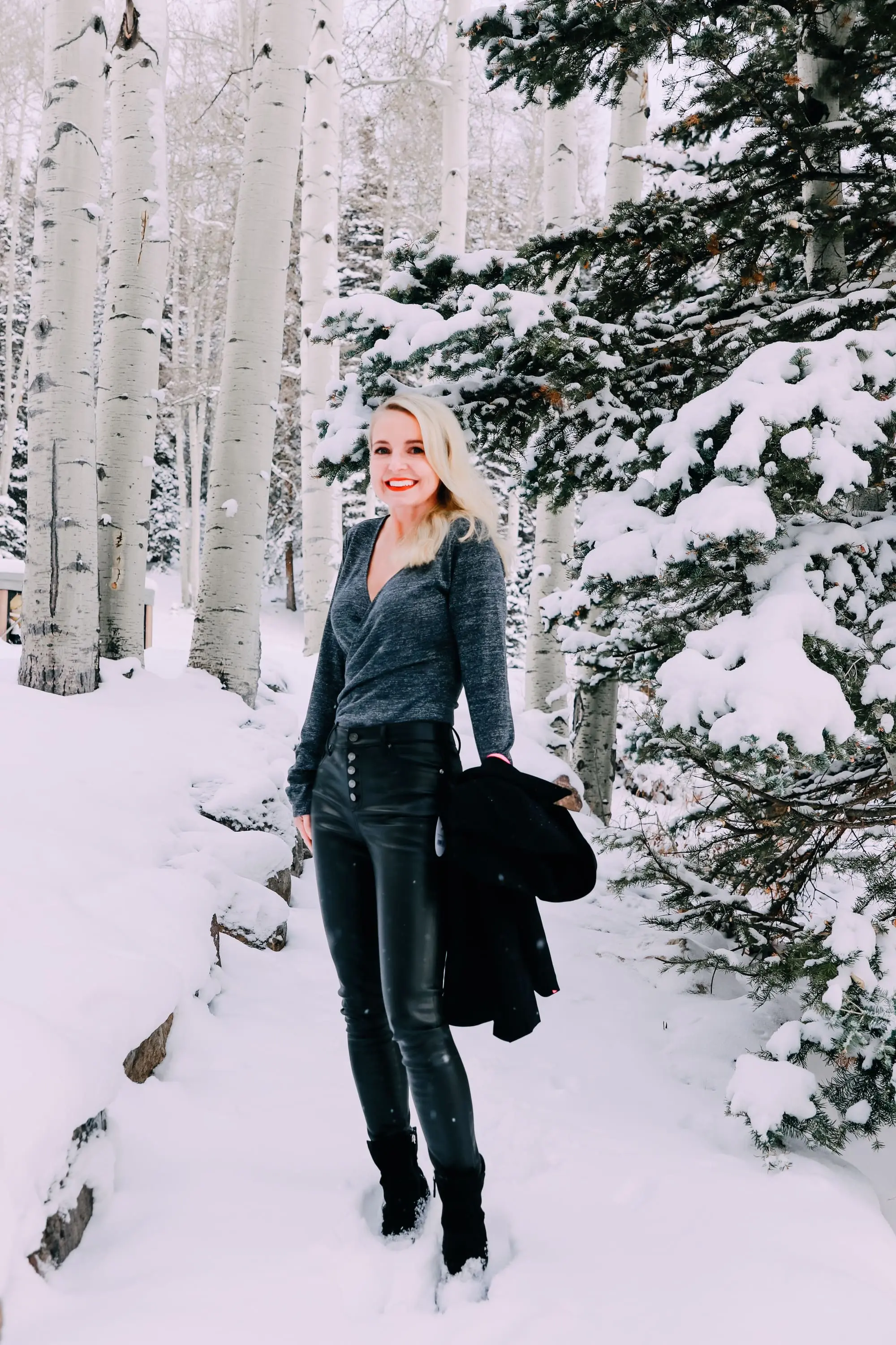 Holiday Party Outfits, Erin Busbee of Busbee Style wearing a black double breasted crepe blazer by Scoop over a metallic wrap style bodysuit but Sofia Vergara with black faux leather high rise skinny jeans by Scoop and black stiletto booties by Scoop in the snow in Telluride, Colorado