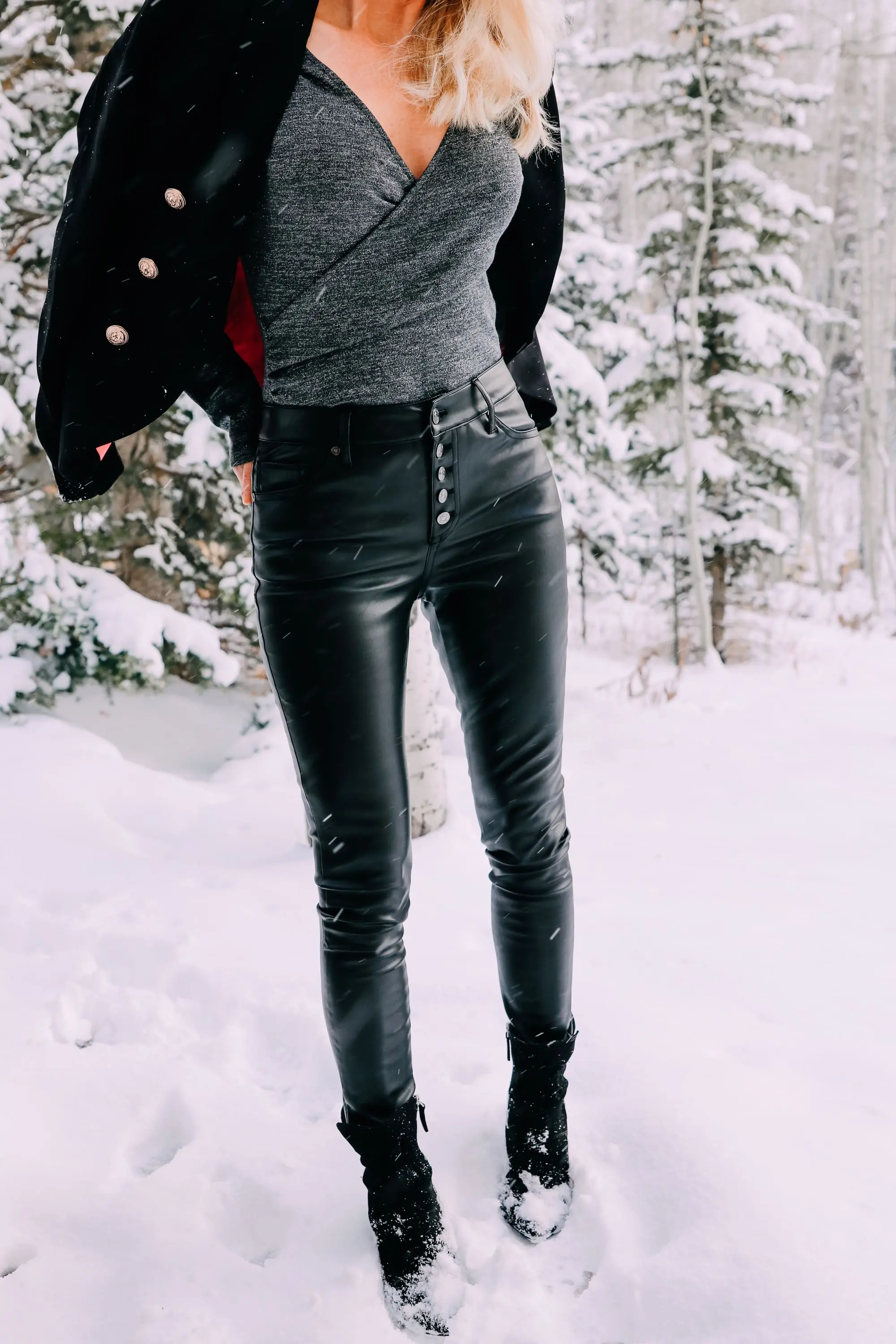 Holiday Party Outfits, Erin Busbee of Busbee Style wearing a black double breasted crepe blazer by Scoop over a metallic wrap style bodysuit but Sofia Vergara with black faux leather high rise skinny jeans by Scoop and black stiletto booties by Scoop in the snow in Telluride, Colorado