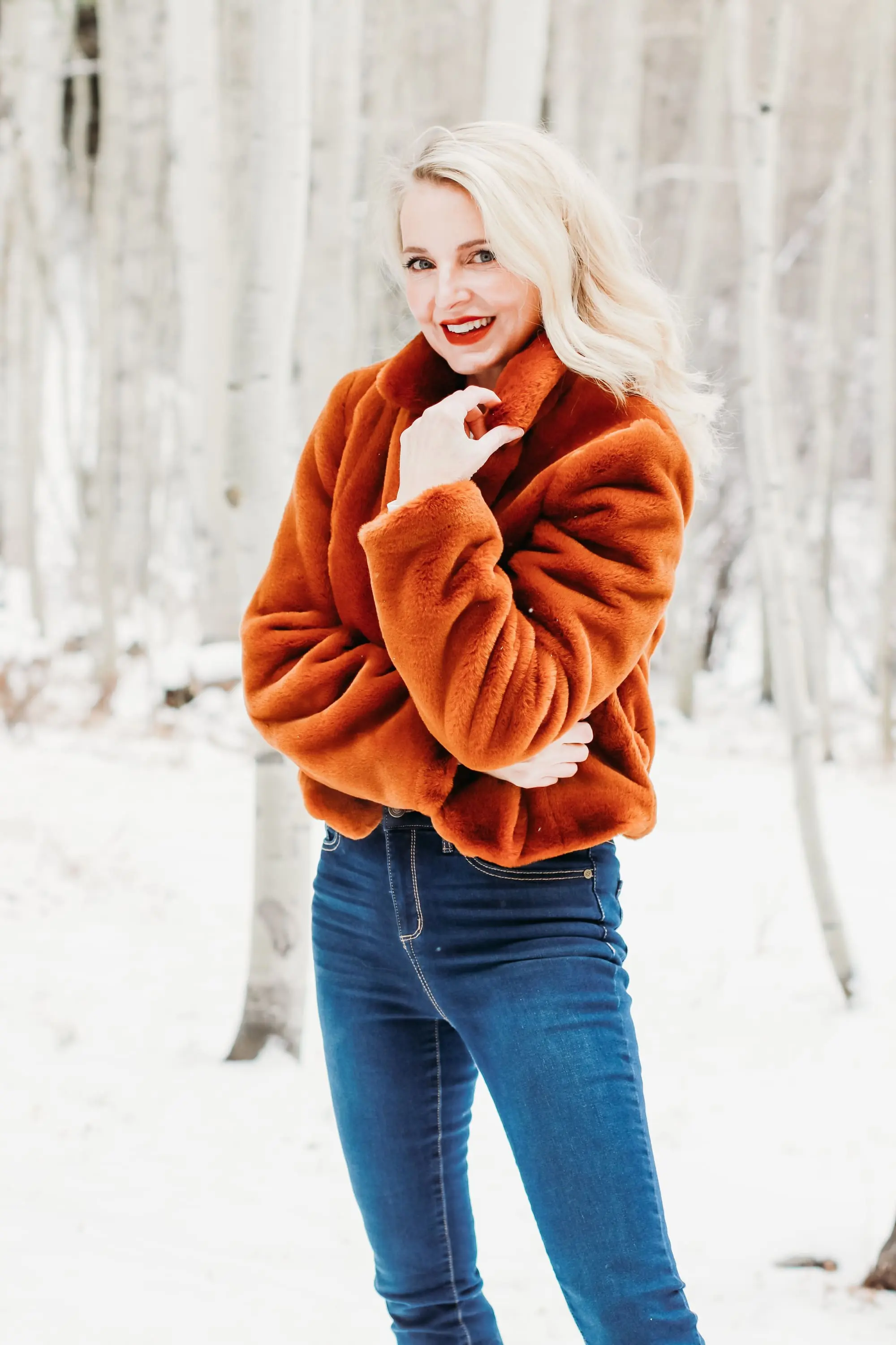 How to Wear Faux fur coat, Erin Busbee of Busbee Style wearing a brwon Blank NYC faux fur jacket with ribbed ruched sleeve sweater and dark wash skinny jeans from Express and Mou woven snow boots standing in the snow in Telluride, Colorado