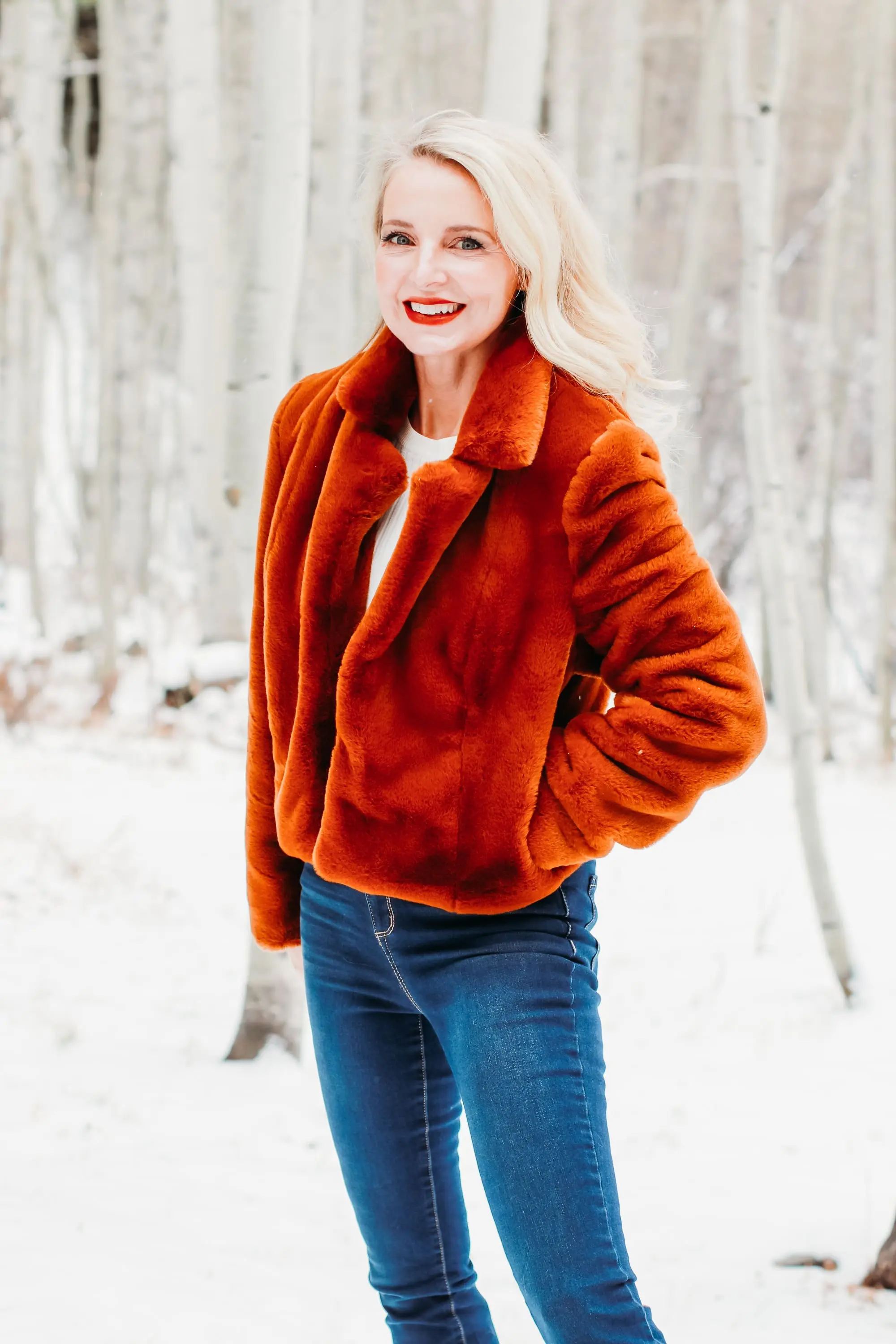 How to Wear Faux fur coat, Erin Busbee of Busbee Style wearing a brwon Blank NYC faux fur jacket with ribbed ruched sleeve sweater and dark wash skinny jeans from Express and Mou woven snow boots standing in the snow in Telluride, Colorado