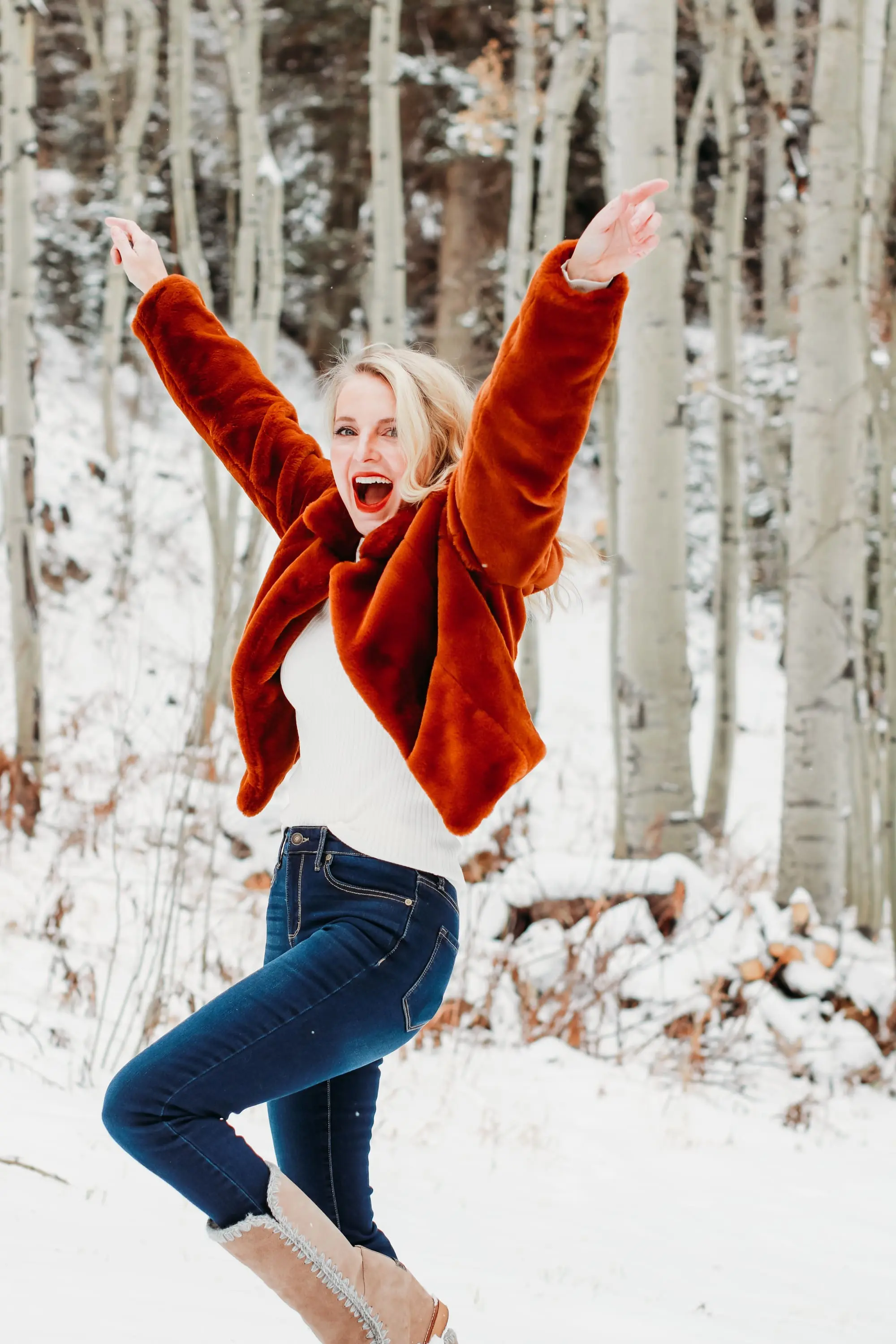 How to Wear Faux fur coat, Erin Busbee of Busbee Style wearing a brwon Blank NYC faux fur jacket with ribbed ruched sleeve sweater and dark wash skinny jeans from Express and Mou woven snow boots standing in the snow in Telluride, Colorado