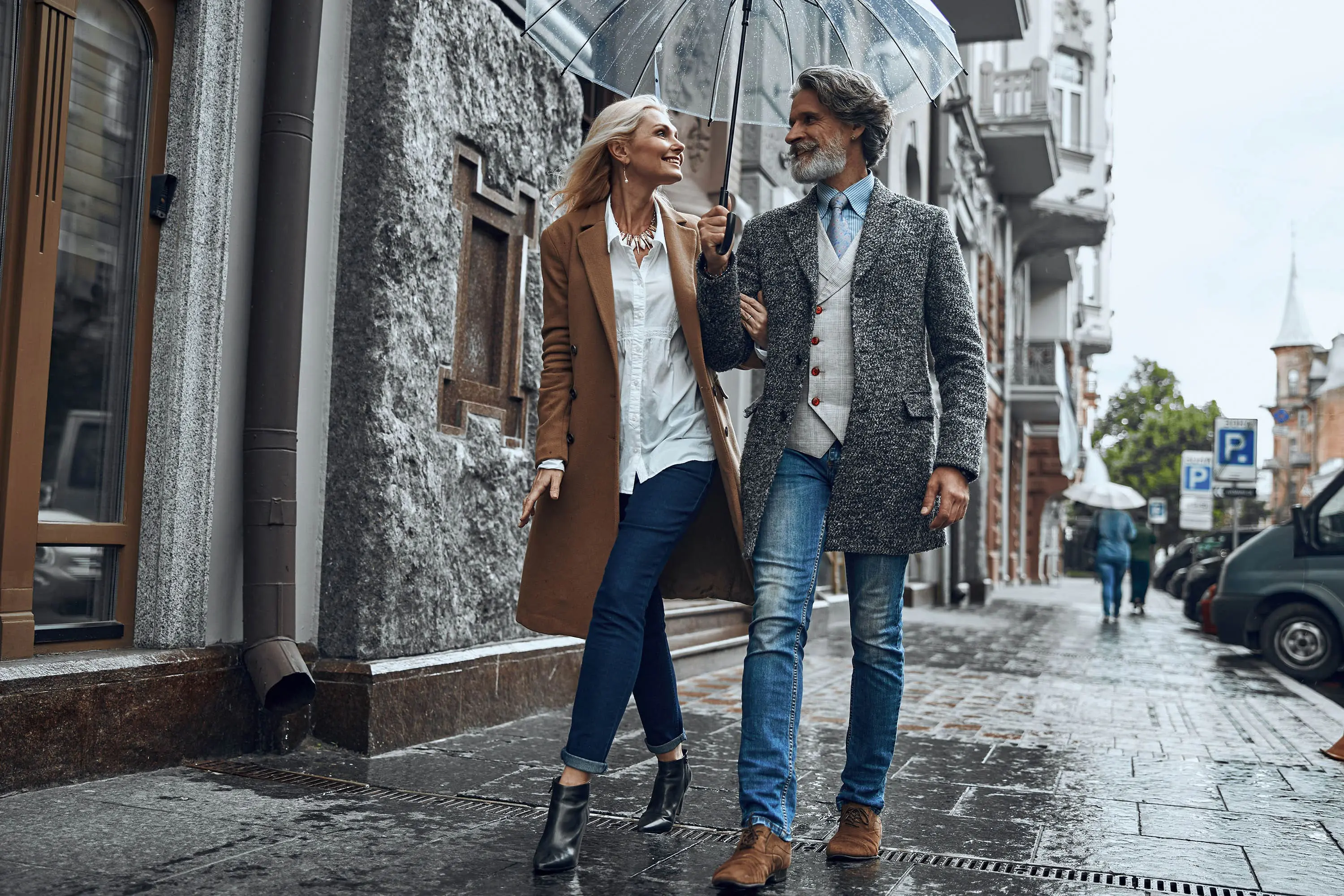 dating over 40, happy stylish couple over 40 walking arm in arm down a city street