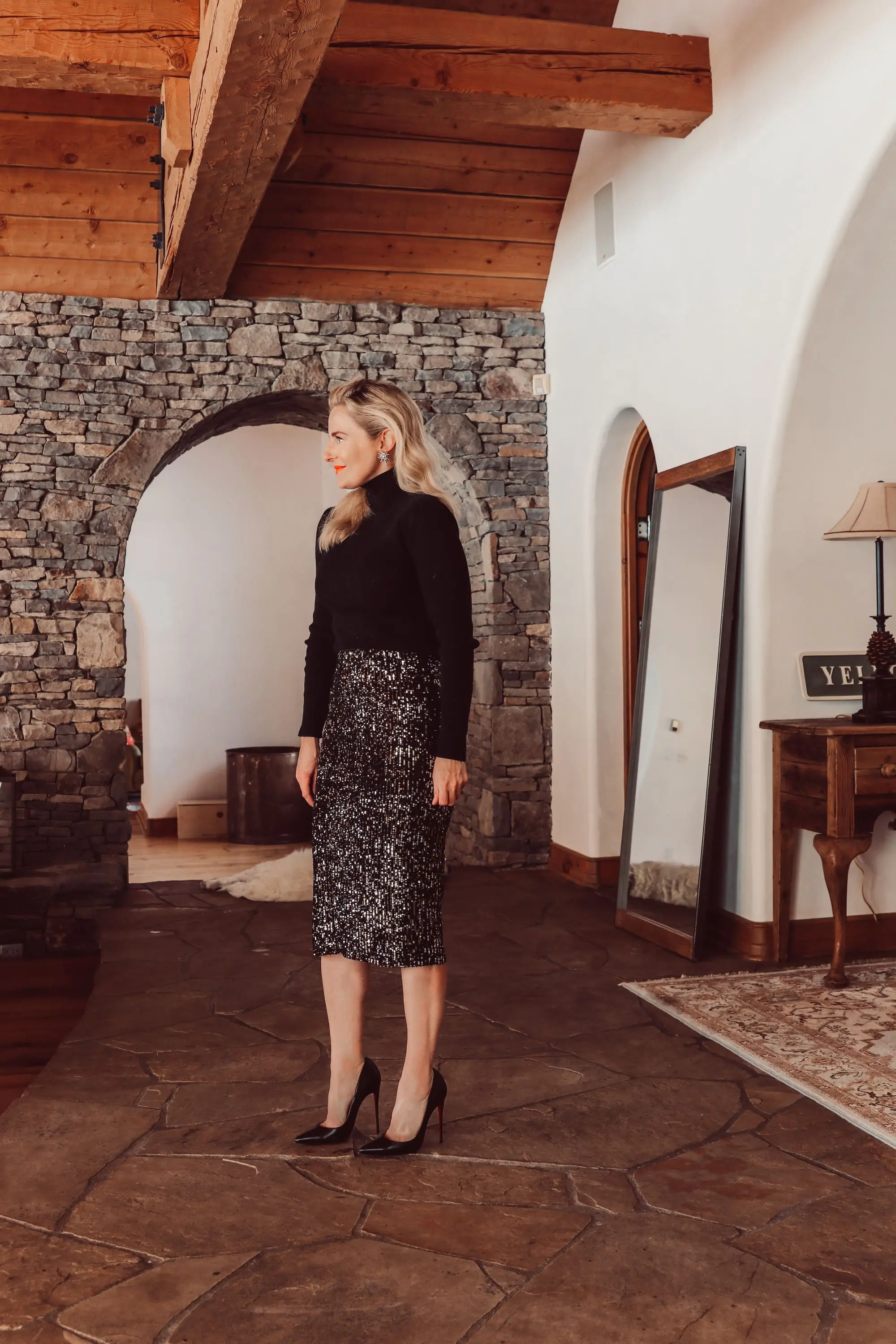 Simple holiday outfit idea featuring sequin midi skirt and black puff shoulder ribbed turtleneck from Walmart on fashion over 40 blogger Erin Busbee