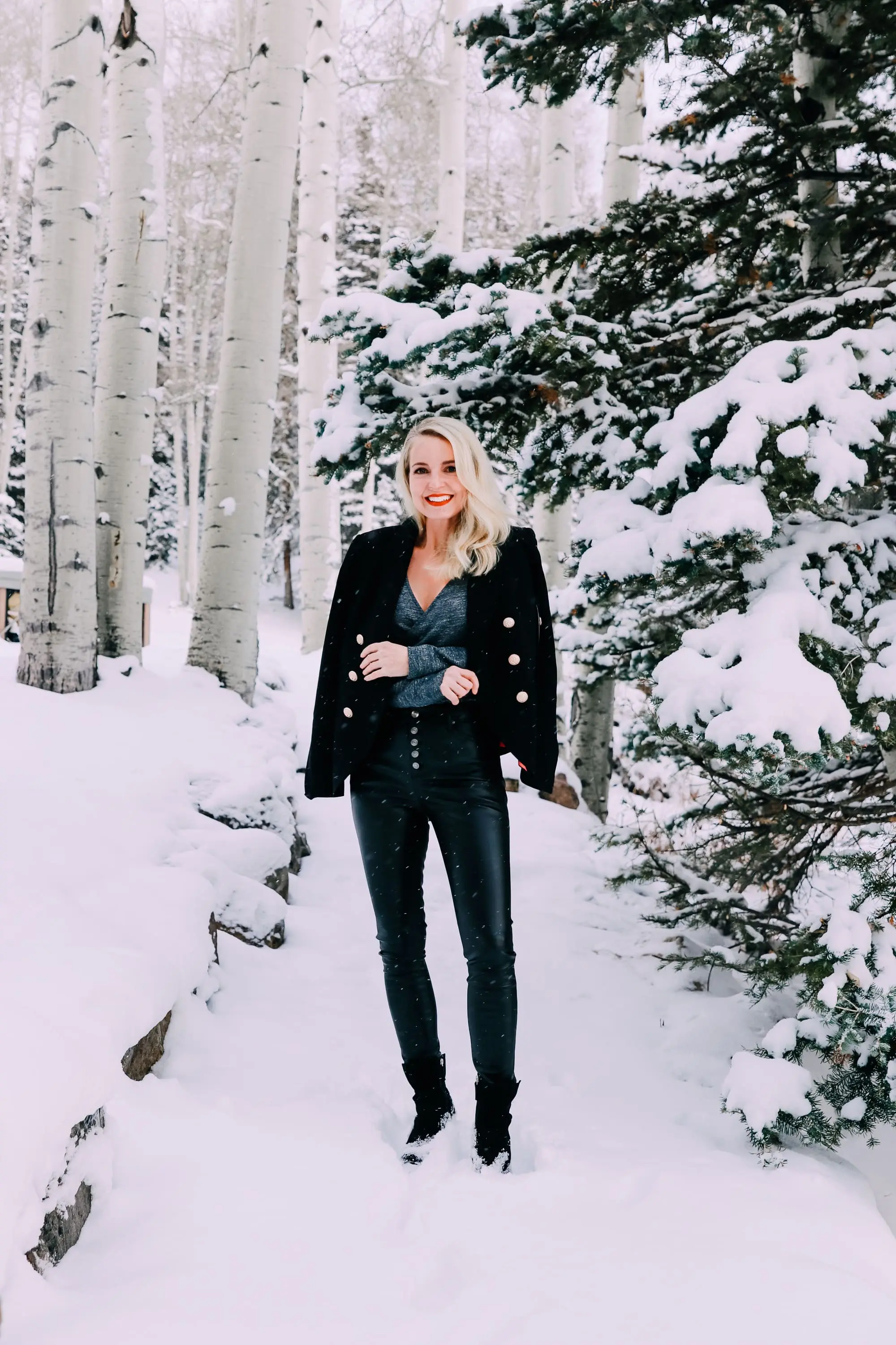 Holiday Party Outfits, Erin Busbee of Busbee Style wearing a black double breasted crepe blazer by Scoop over a metallic wrap style bodysuit but Sofia Vergara with black faux leather high rise skinny jeans by Scoop and black stiletto booties by Scoop in the snow in Telluride, Colorado