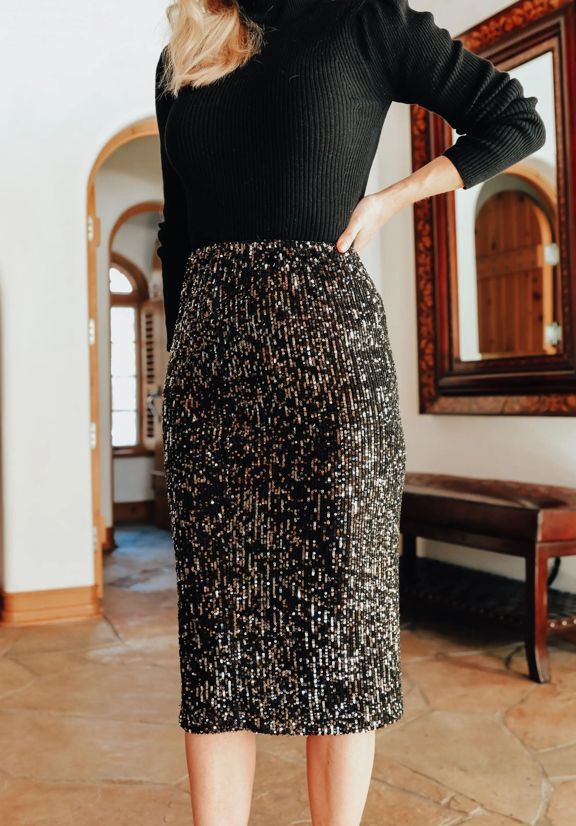 Simple holiday outfit idea featuring sequin midi skirt and black puff shoulder ribbed turtleneck from Walmart on fashion over 40 blogger Erin Busbee