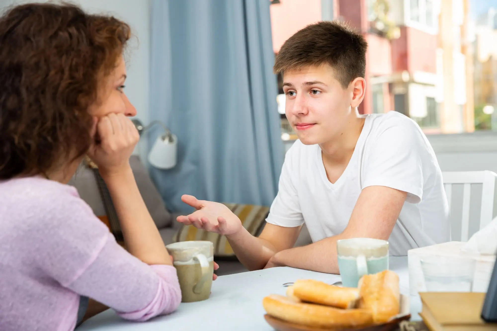 talking about sex, mother in the kitchen listening to her teenage son