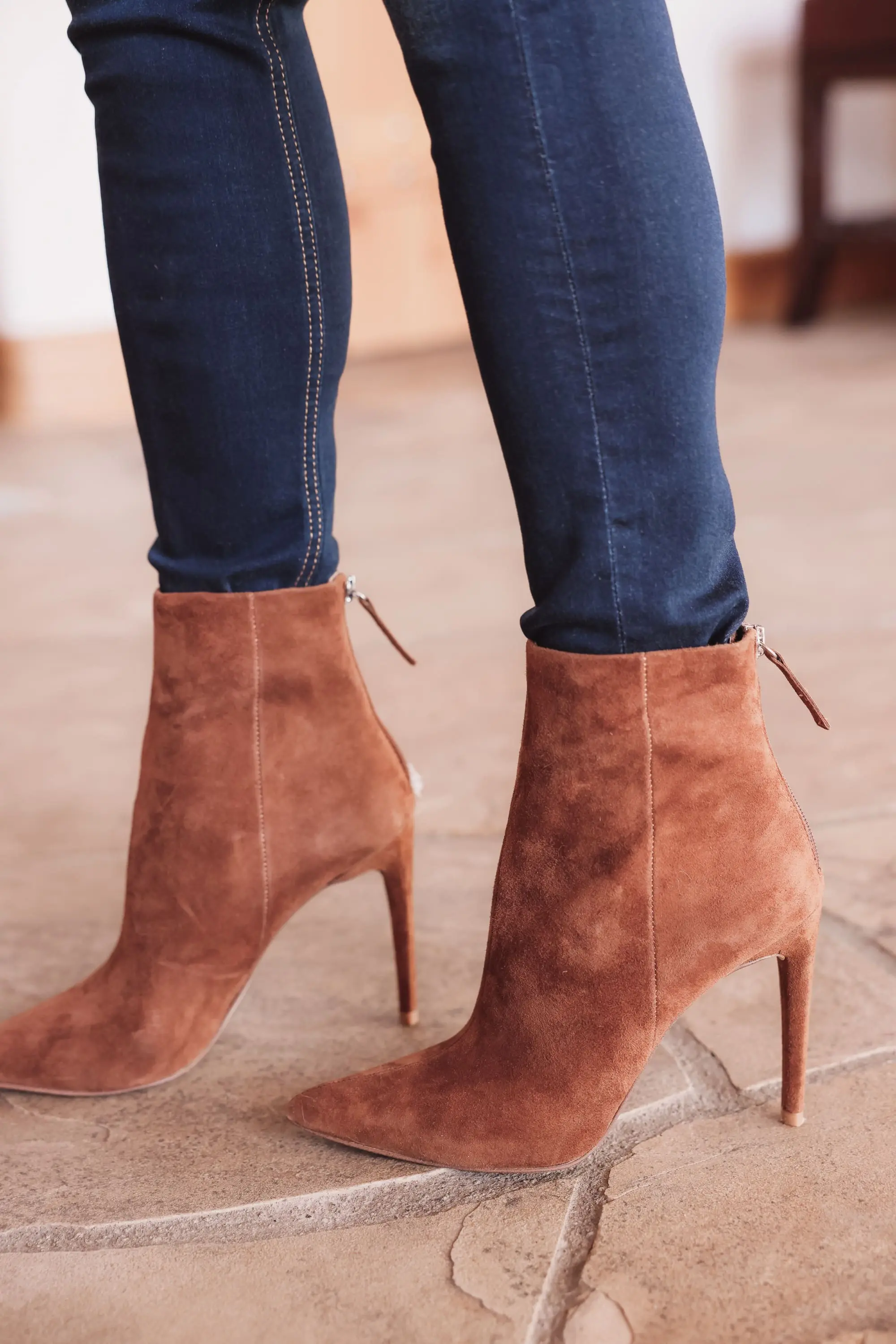 Best brown booties, Erin Busbee of Busbee wearing an ASTR the Label sculptural sleeve sweater with rag & bone skinny jeans and brown suede stiletto heel booties by Steve Madden from Nordstrom in Telluride, Colorado