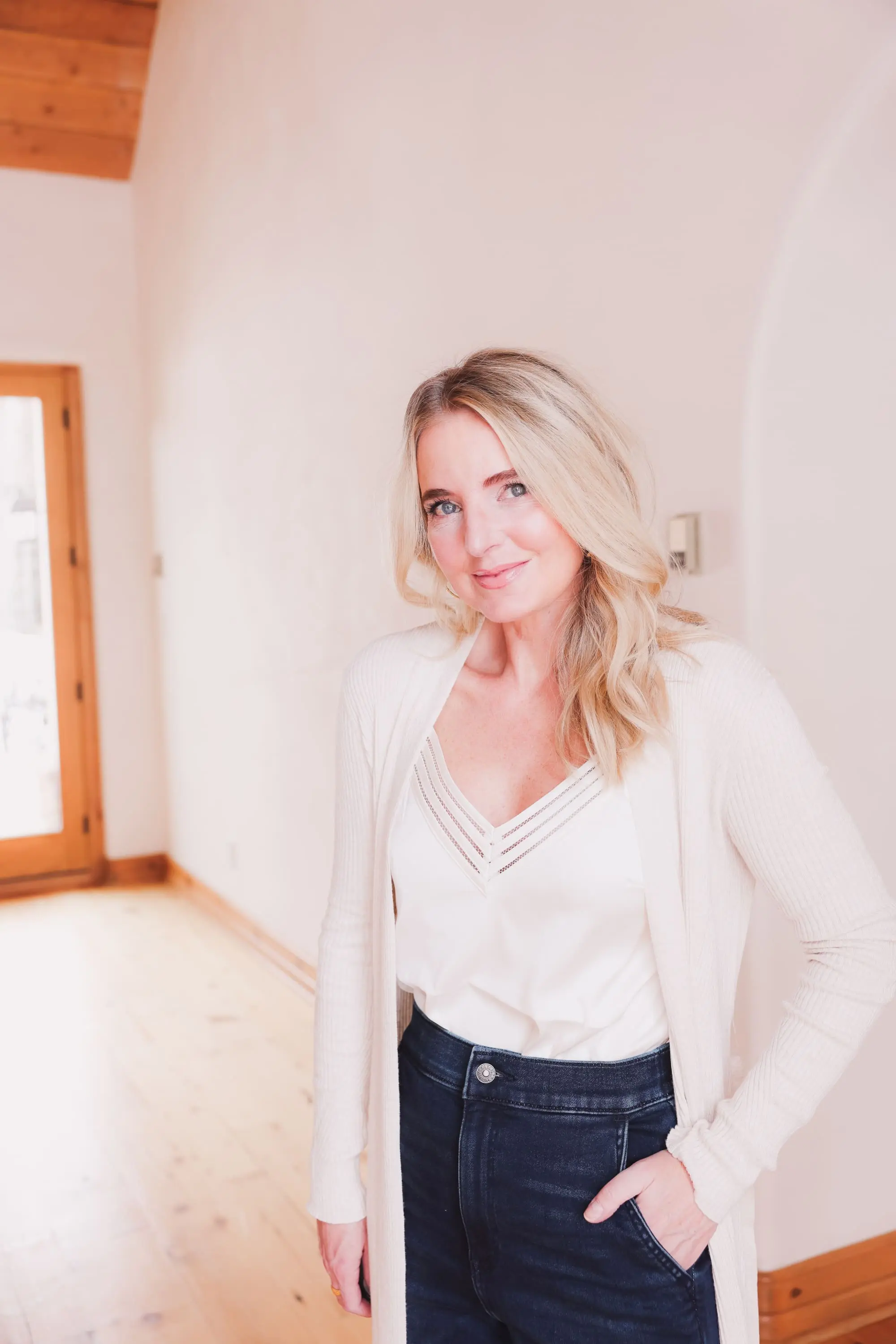 Express Sale, Erin Busbee of Busbee wearing denim joggers, a white satin cami, and long ribbed duster cardigan from Express with Steve Madden brown booties in Telluride, Colorado
