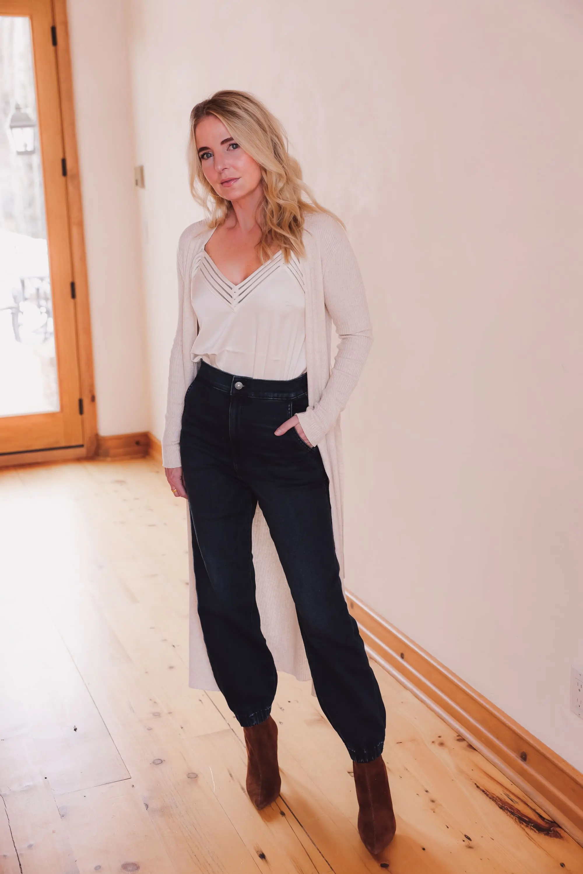 Express Sale, Erin Busbee of Busbee wearing denim joggers, a white satin cami, and long ribbed duster cardigan from Express with Steve Madden brown booties in Telluride, Colorado