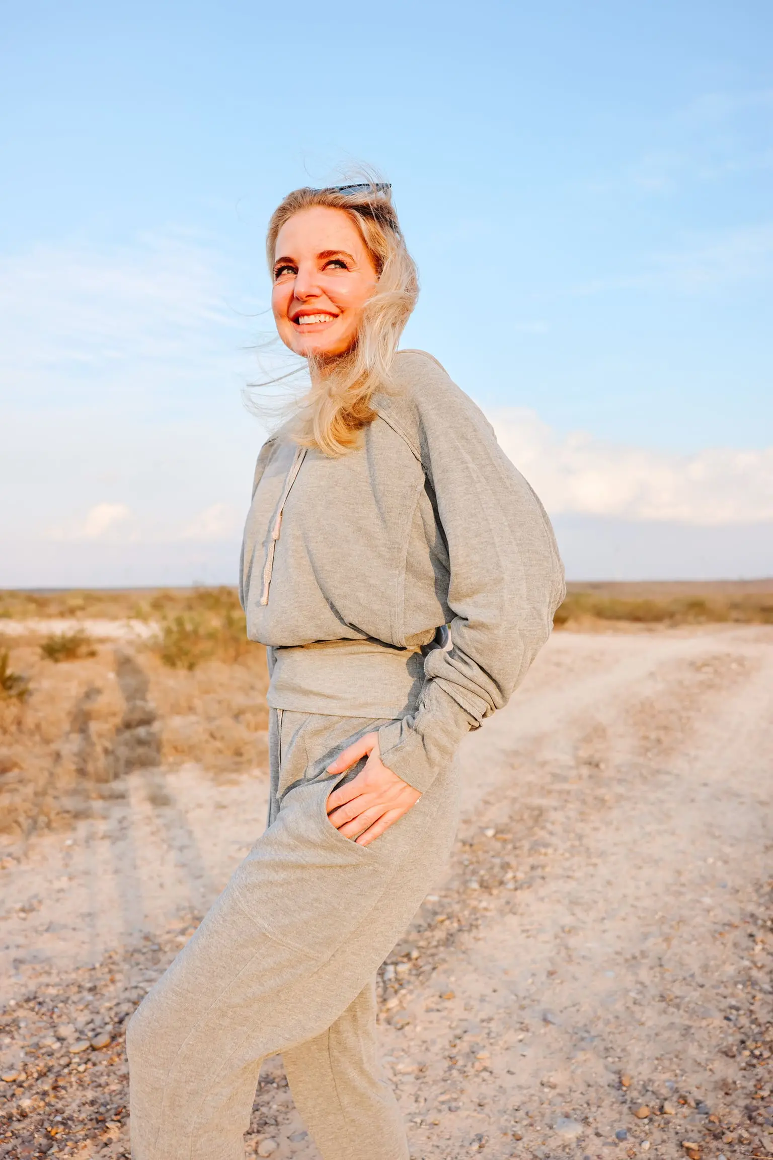 Cozy Loungewear, Erin Busbee of Busbee wearing the grey ready go hoodie by Free People with matching gray ready go pants from Free People with black golden goose sneakers in south texas