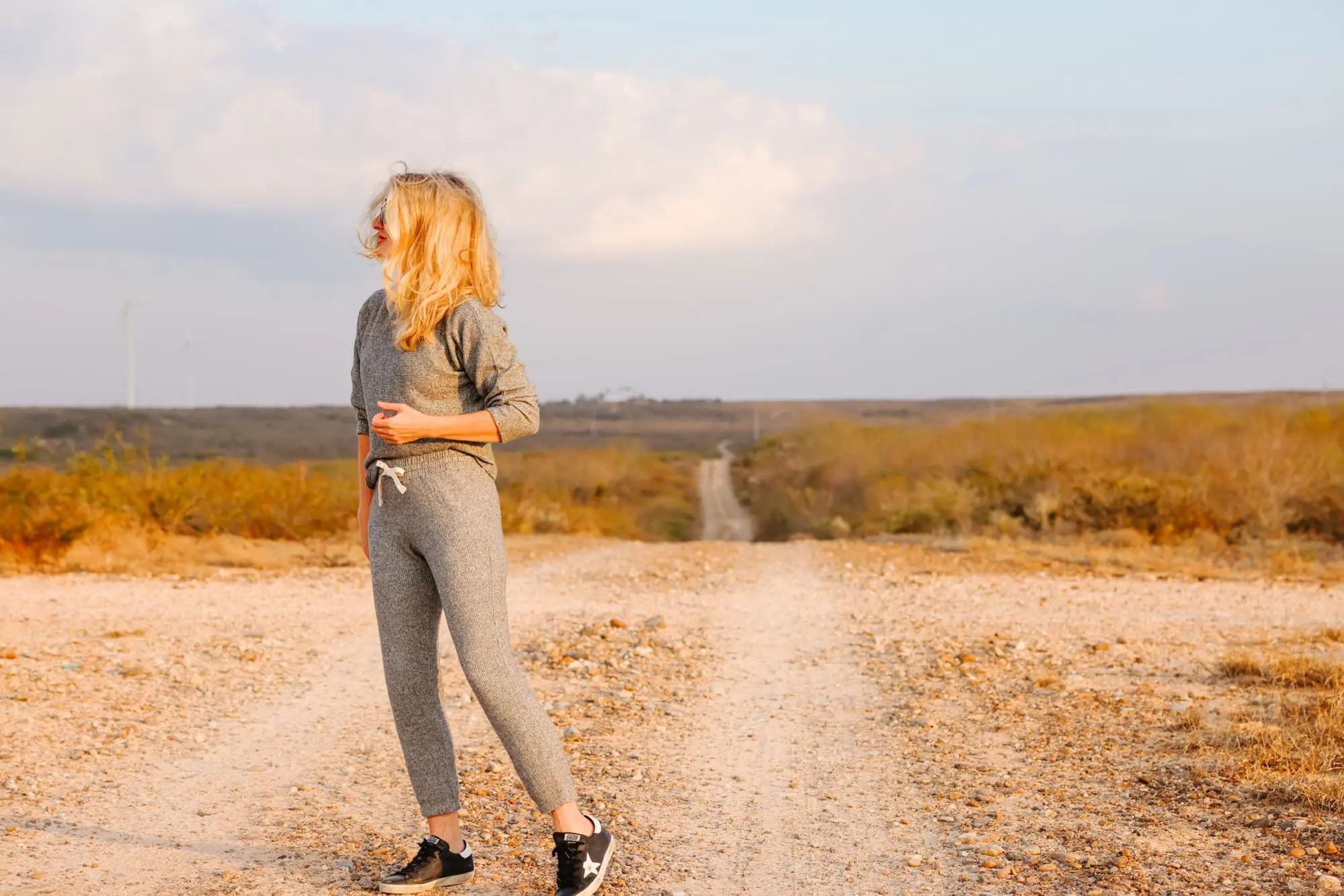 Cozy Loungewear, Erin Busbee of Busbee wearing a gray thermal sweatshirt by Monrow with matching gray thermal joggers by Monrow with black Golden Goose sneakers in South Texas