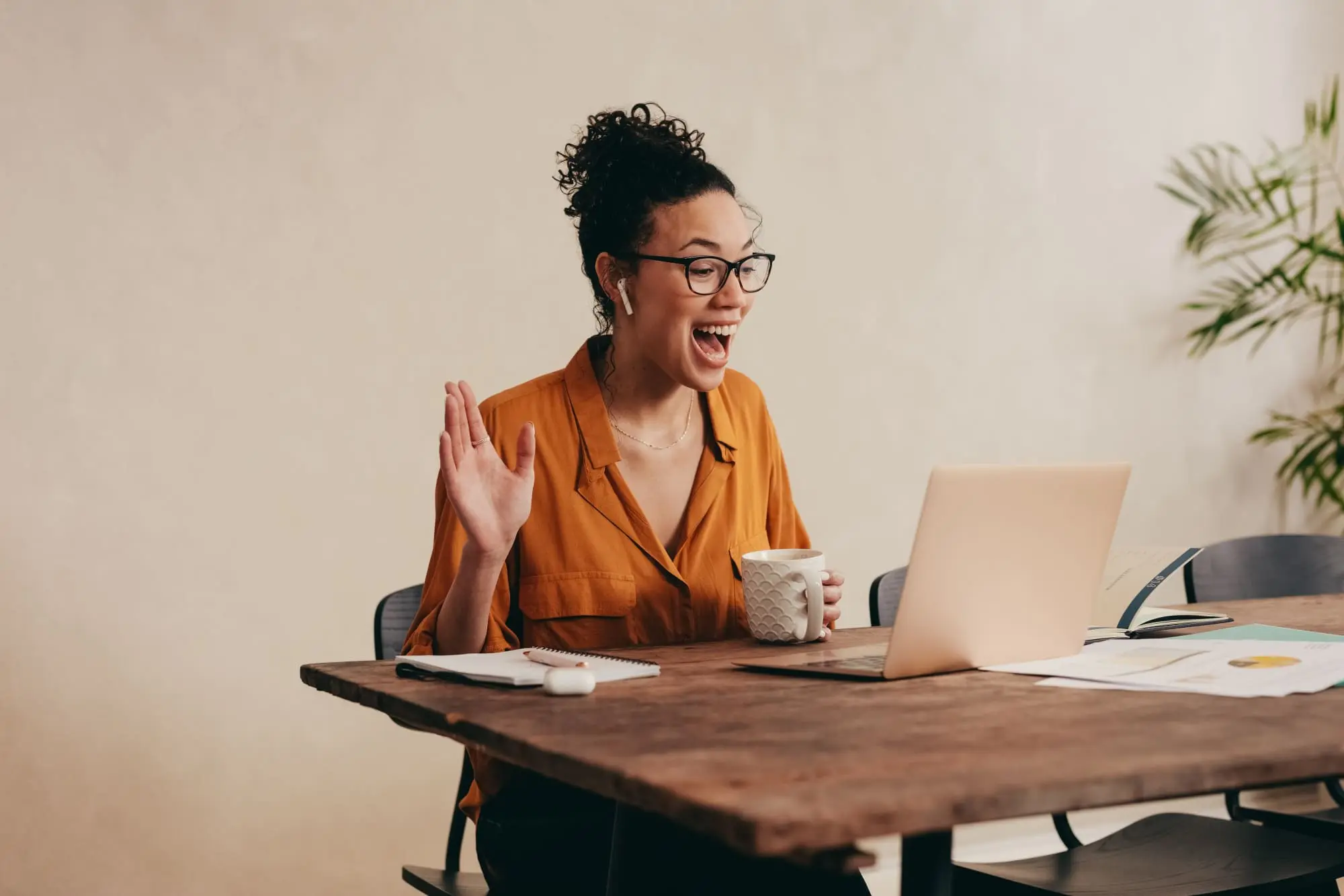 How-to-plan-a-Galentines-Day-zoom-party-celebration-your-friends-will-love-as-a-women-sits-at-a-table-for-the-zoom-party