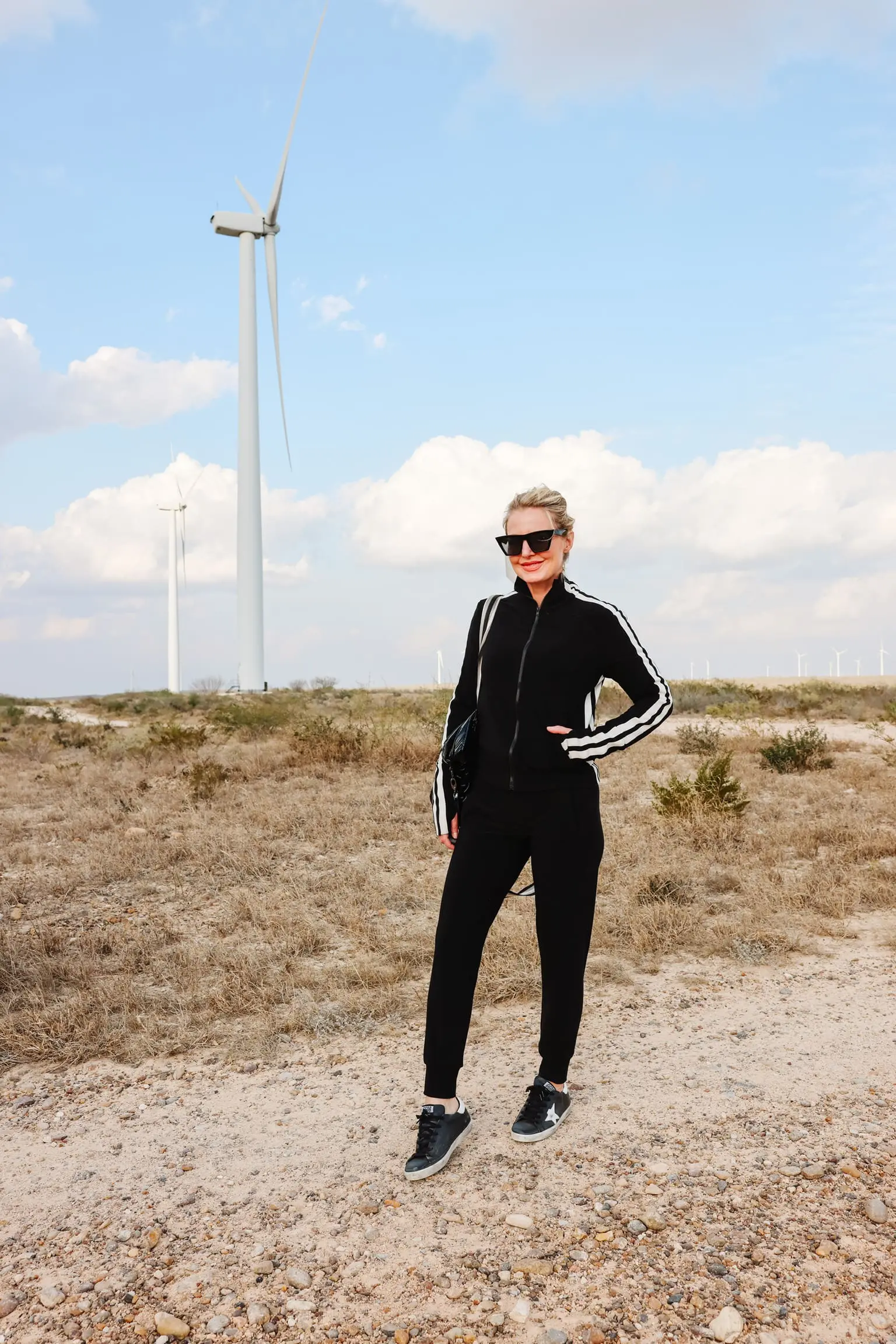 Cozy Loungewear, Erin Busbee of Busbee wearing a black striped Norma Kamali jacket with black norma kamali joggers and black golden goose sneakers carrying a think royln tote in South Texas, outfits without jeans, outfit without jeans, outfits without jeans over 40, casual no jean outfit, what to wear instead of jeans 2022