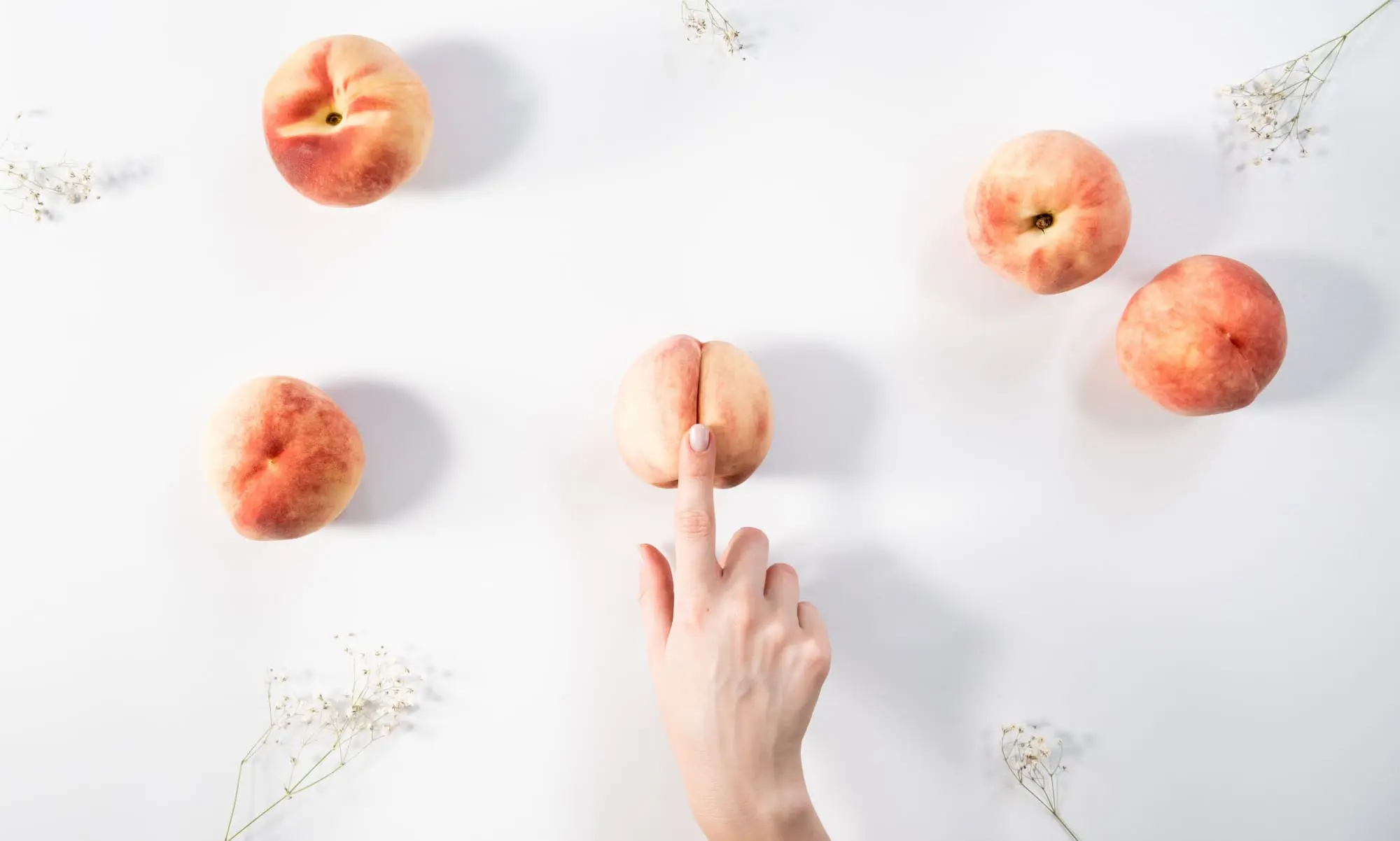 better sex after menopause, Finger on peach on white background