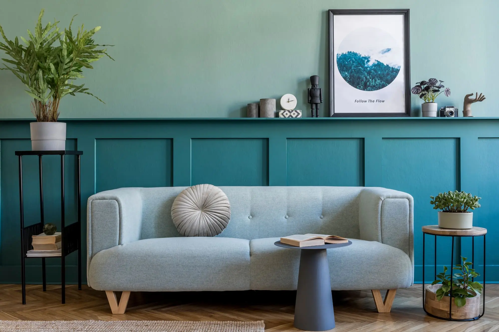 Japandi design muted green wall mixed with neutral colored couch and decor