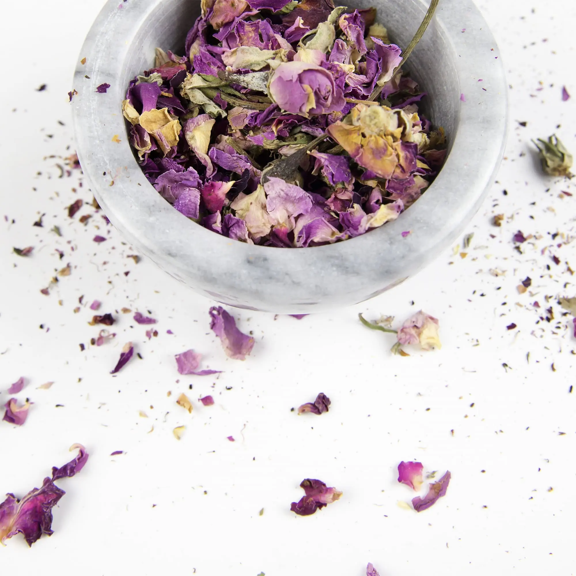 better sex after menopause, pink and purple petals in white marble bowl essential oils