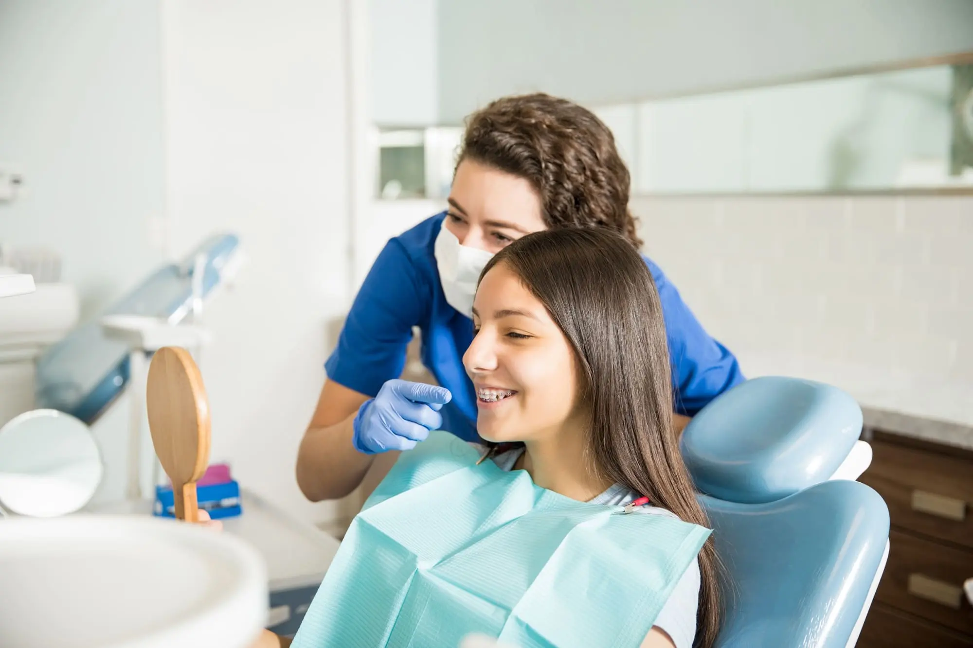 budget for when you have teens, teen girl at the orthodontist smiling with braces