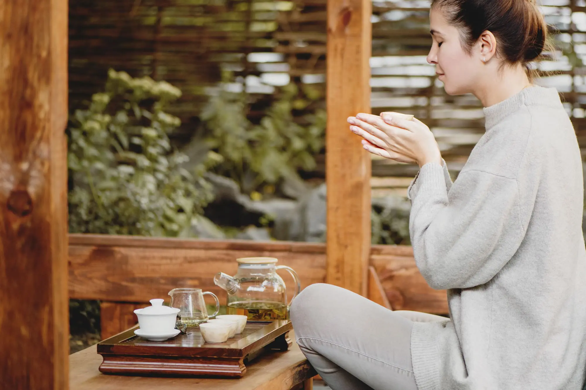 common menopause questions, Brunette in grey performing tea ritual
