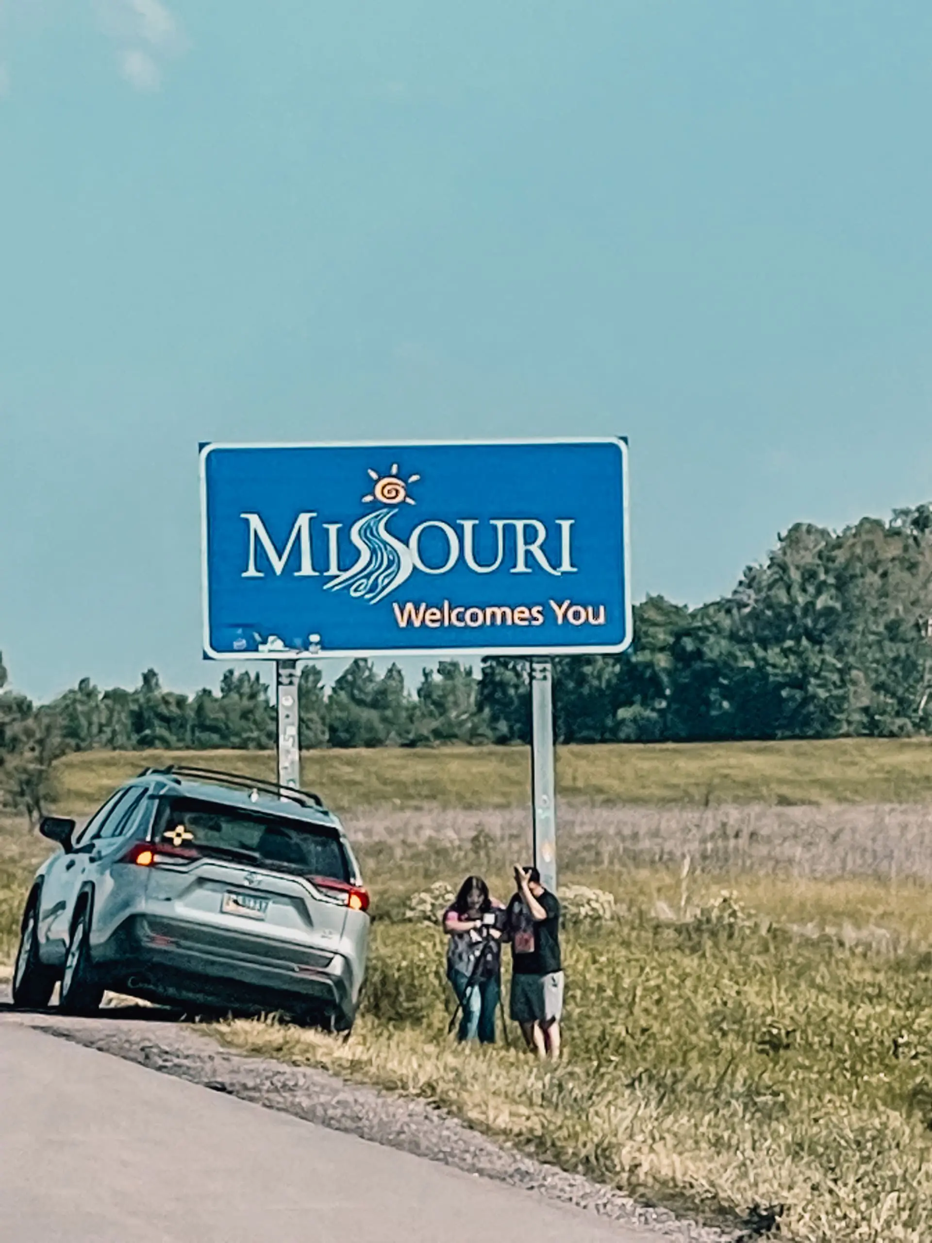 where to stop on a cross-country road trip, best places to stop on a cross country road trip, cross country road trip, west coast to east coast road trip, erin busbee, traveling with kids, how to travel with kids, how to travel with a dog, cross country road trip with kids, missouri state line welcome sign, cross country busbee style, family road trip