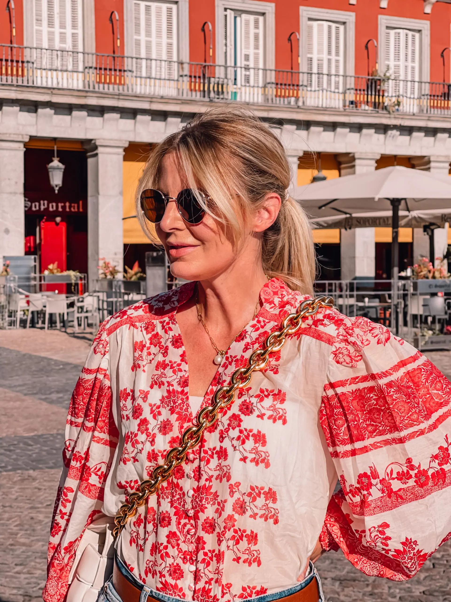 what to wear in spain, how to dress in spain, madrid, how to dress in madrid, what to wear in madrid, how to pack for a trip to spain, trip to spain, packing for spain, erin busbee, alice + olivia red printed blouse, moussy denim shorts, golden goose sneakers, bottega veneta chain cassette bag, valentino belt