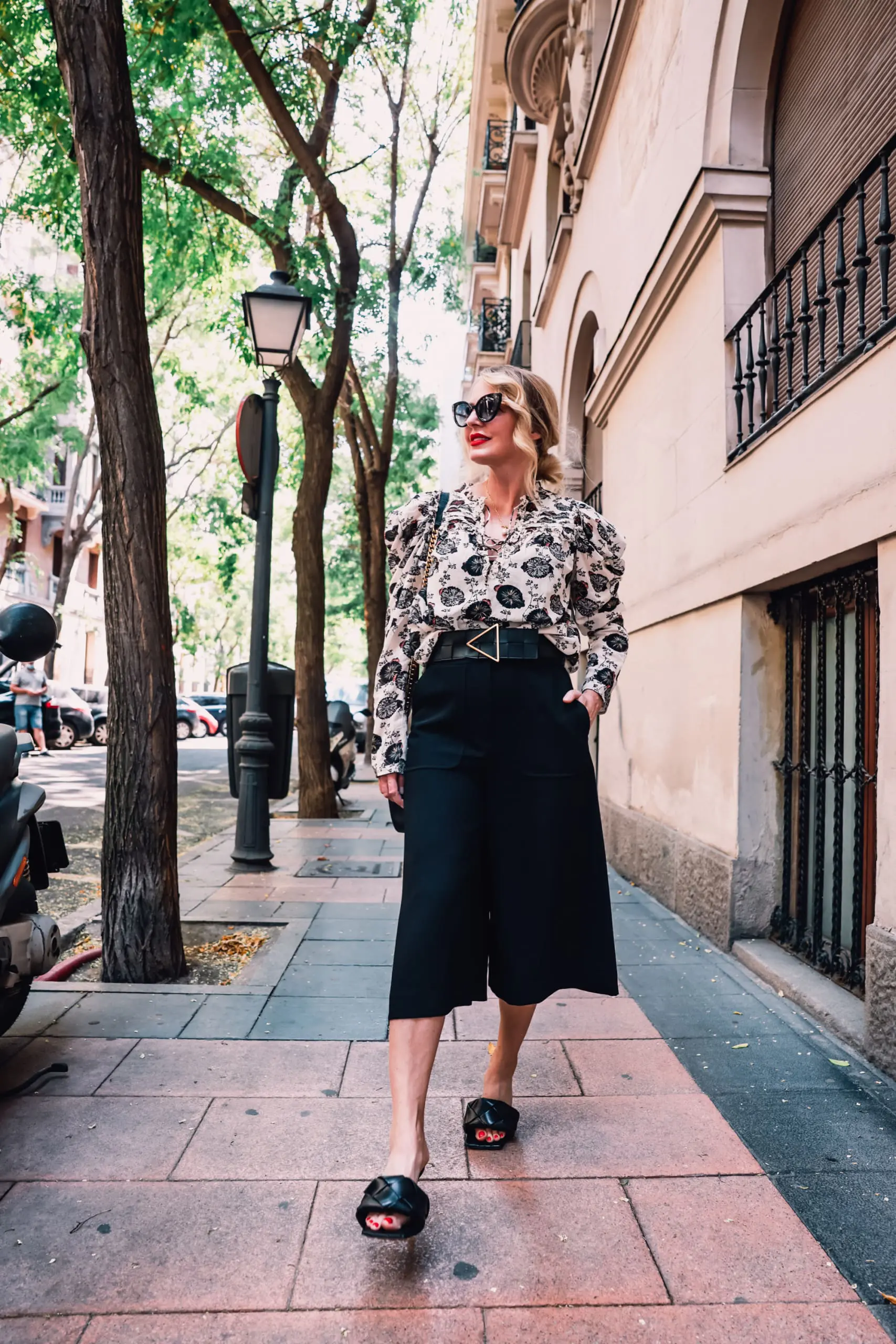 how to wear culottes, why wear culottes, how to style culottes, wear culottes, style culottes, how to wear culottes over 40, styling culottes over 40, erin busbee, see by chloe culottes, bottega veneta lido heels, ulla johnson printed floral blouse, bottega veneta belt, saint laurent leather and suede chevron bag, neiman marcus, madrid, spain