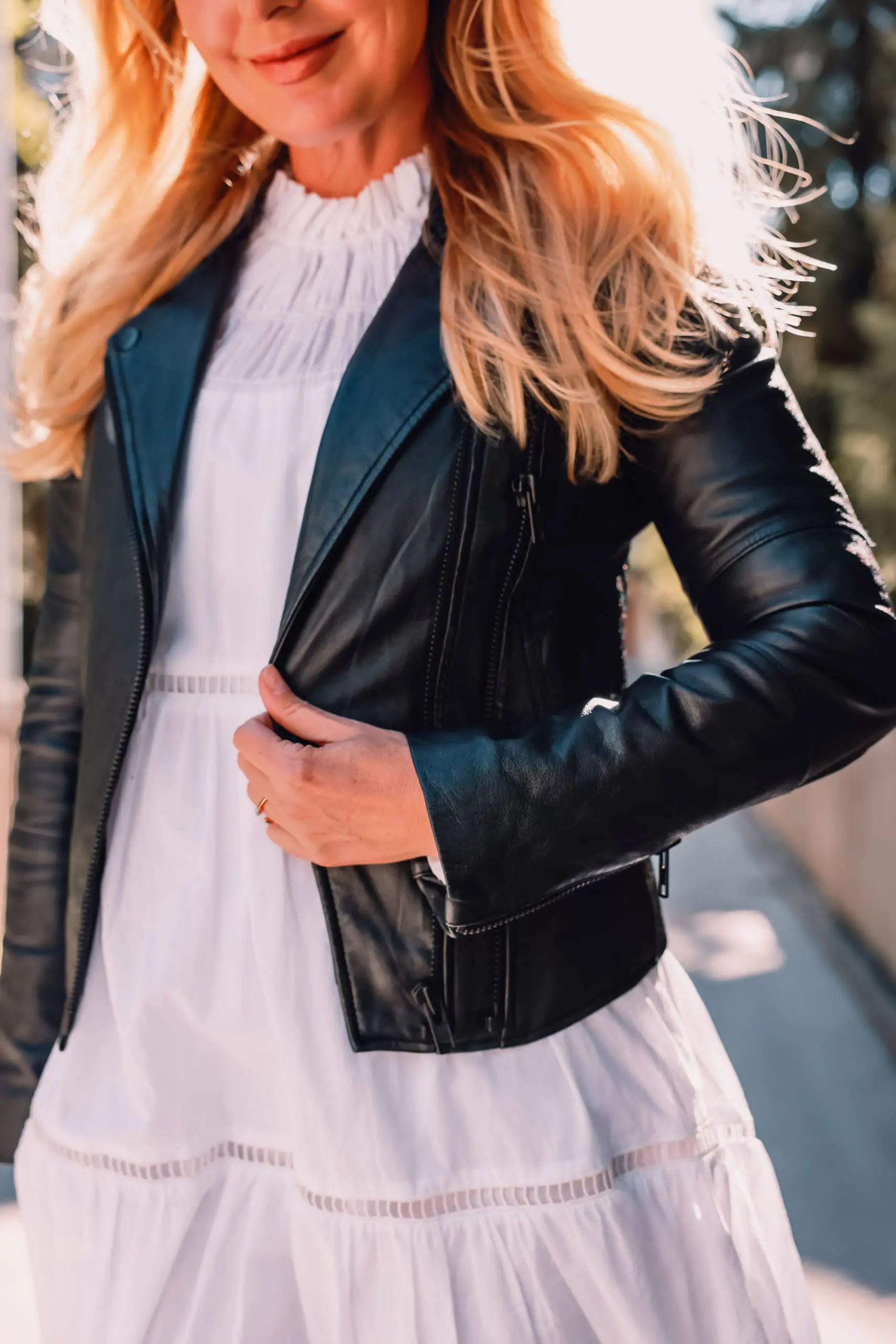 ways to wear a moto jacket, how to wear a moto jacket, moto jackets over 40, how to wear a moto jacket over 40, wearing moto jackets, how to style a moto jacket over 40, erin busbee, black leather moto jacket, white michael kors dress, black Paige side zip booties, zermatt switzerland