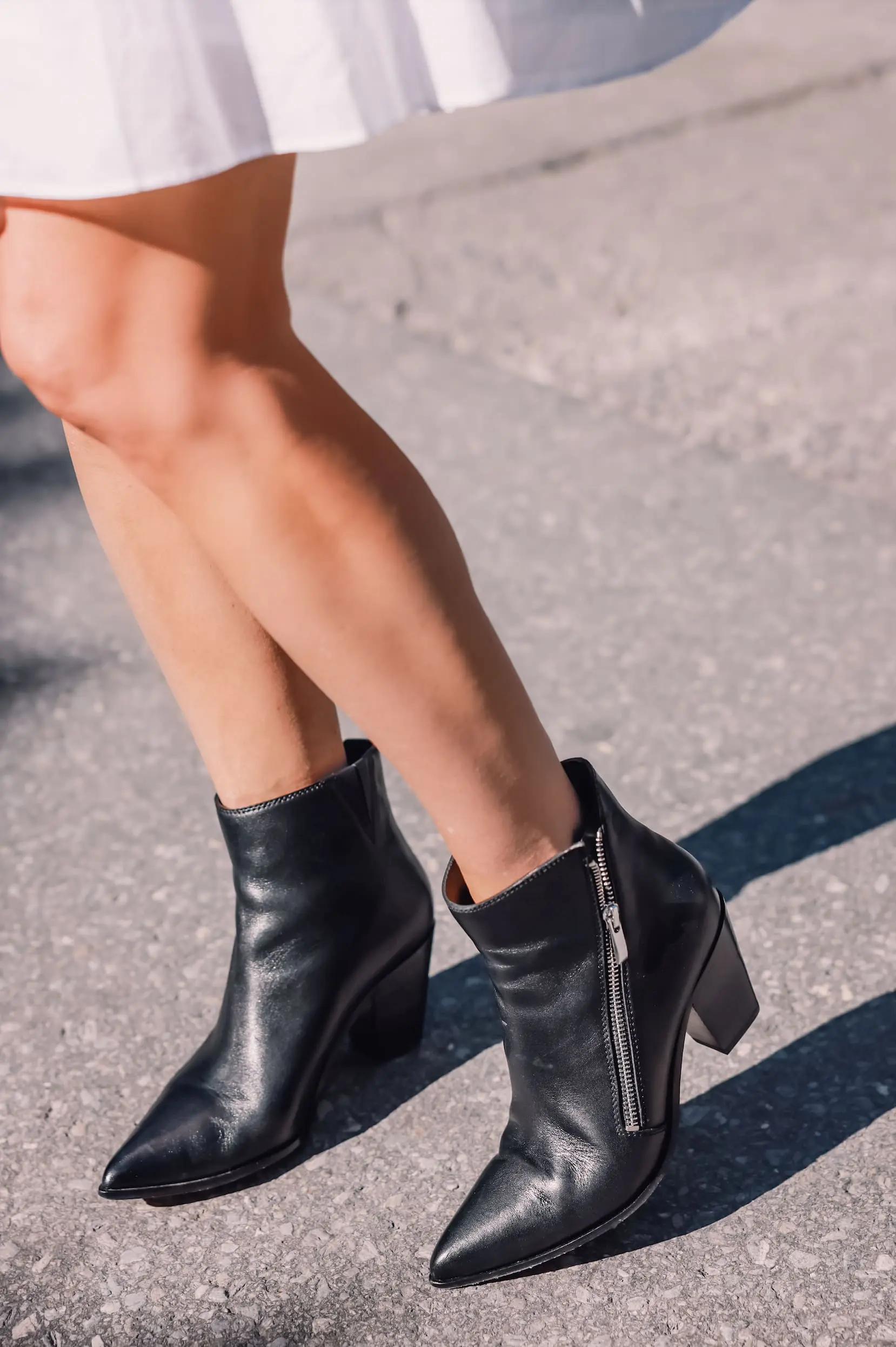 ways to wear a moto jacket, how to wear a moto jacket, moto jackets over 40, how to wear a moto jacket over 40, wearing moto jackets, how to style a moto jacket over 40, erin busbee, black leather moto jacket, white michael kors dress, black Paige side zip booties, zermatt switzerland