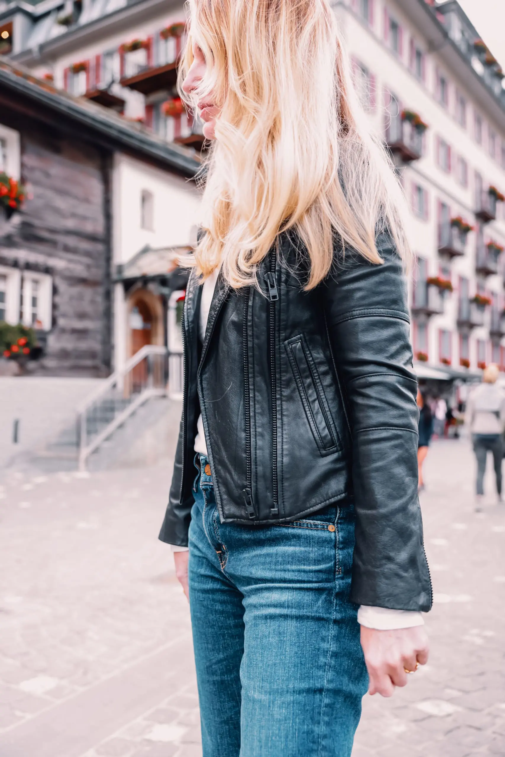 ways to wear a moto jacket, how to wear a moto jacket, moto jackets over 40, how to wear a moto jacket over 40, wearing moto jackets, how to style a moto jacket over 40, erin busbee, black leather moto jacket, free people natasha tee, ag ex-boyfriend relaxed fit jeans, black Paige side zip booties, zermatt switzerland