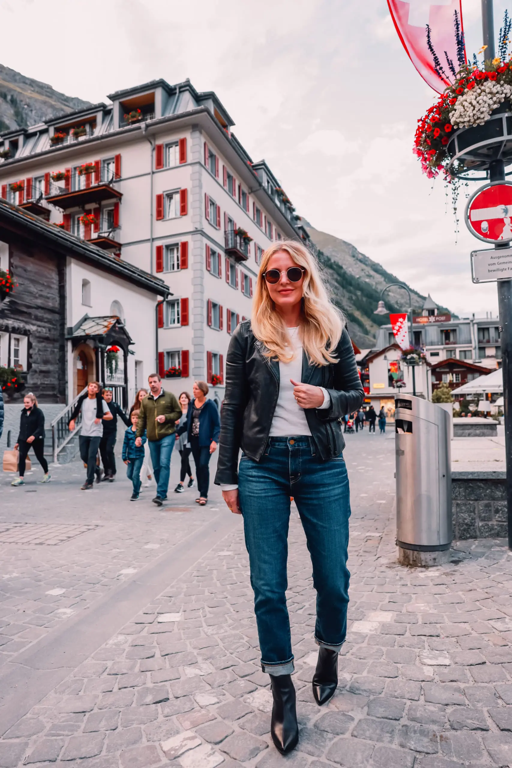 ways to wear a moto jacket, how to wear a moto jacket, moto jackets over 40, how to wear a moto jacket over 40, wearing moto jackets, how to style a moto jacket over 40, erin busbee, black leather moto jacket, free people natasha tee, ag ex-boyfriend relaxed fit jeans, black Paige side zip booties, zermatt switzerland