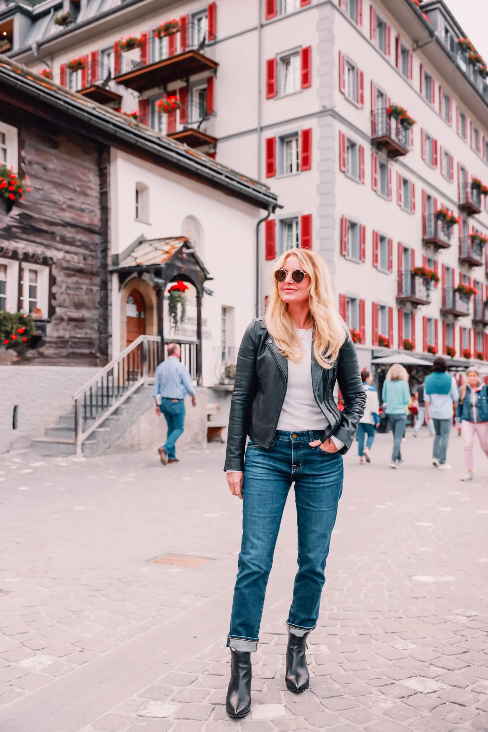 ways to wear a moto jacket, how to wear a moto jacket, moto jackets over 40, how to wear a moto jacket over 40, wearing moto jackets, how to style a moto jacket over 40, erin busbee, black leather moto jacket, free people natasha tee, ag ex-boyfriend relaxed fit jeans, black Paige side zip booties, zermatt switzerland