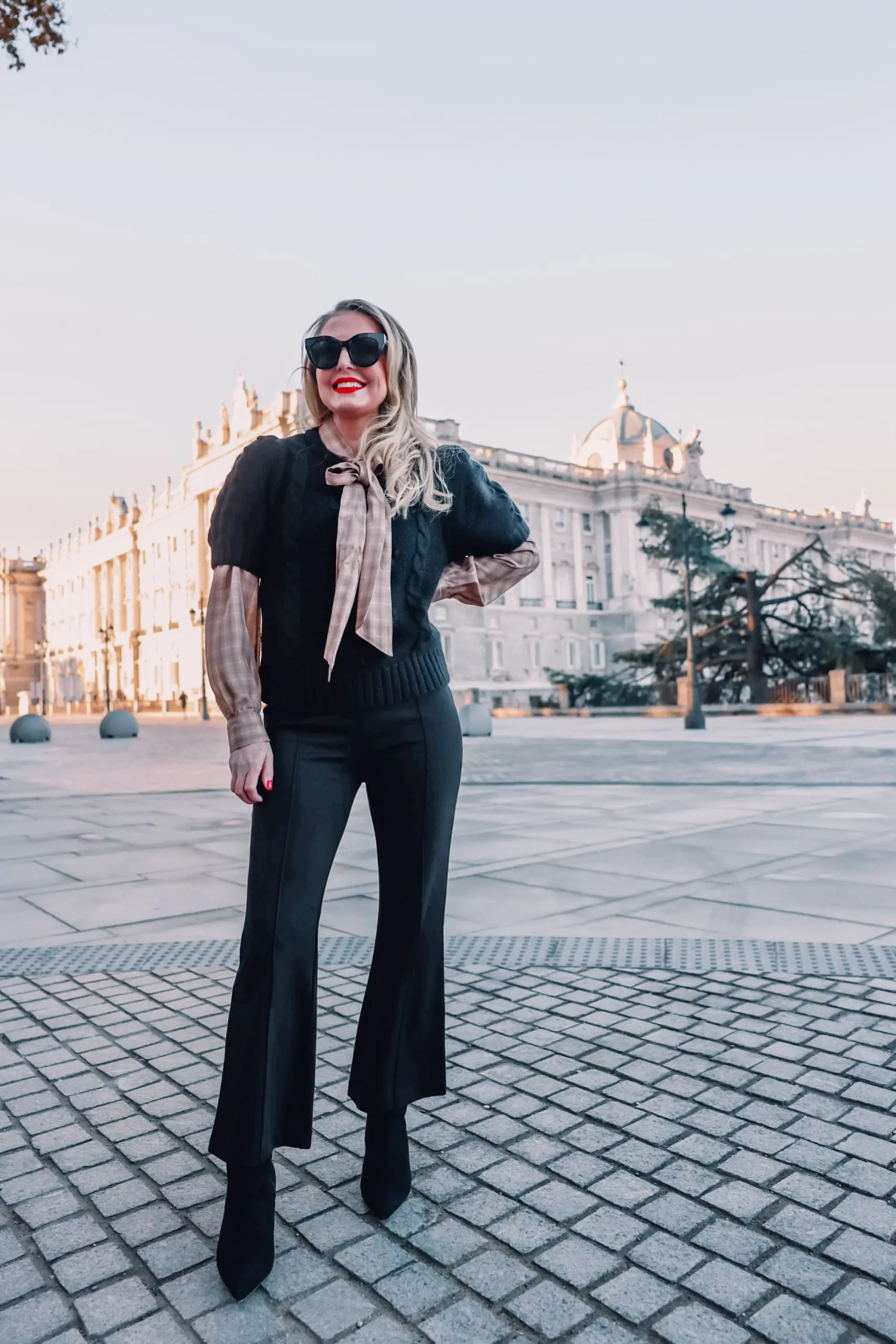 how to wear plaid, plaid, ways to wear plaid, plaid outfit, plaid over 40, erin busbee, & other stories check tie neck blouse, & other stories bobble and cable knit puff sleeve sweater, black & other stories flare pants, black schutz bette booties, madrid, spain