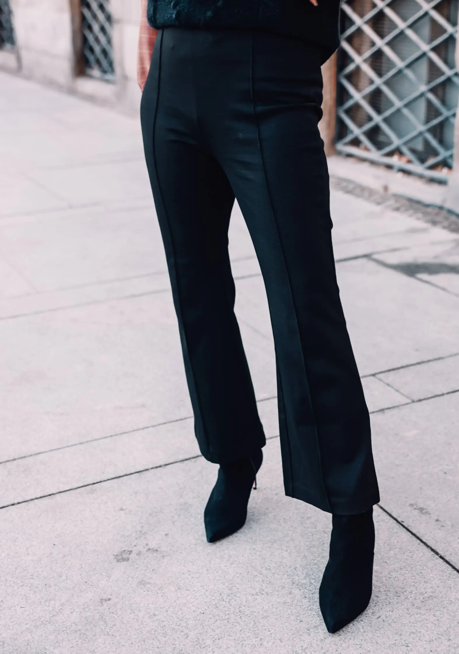 how to wear plaid, plaid, ways to wear plaid, plaid outfit, plaid over 40, erin busbee, & other stories check tie neck blouse, & other stories bobble and cable knit puff sleeve sweater, black & other stories flare pants, black schutz bette booties, madrid, spain