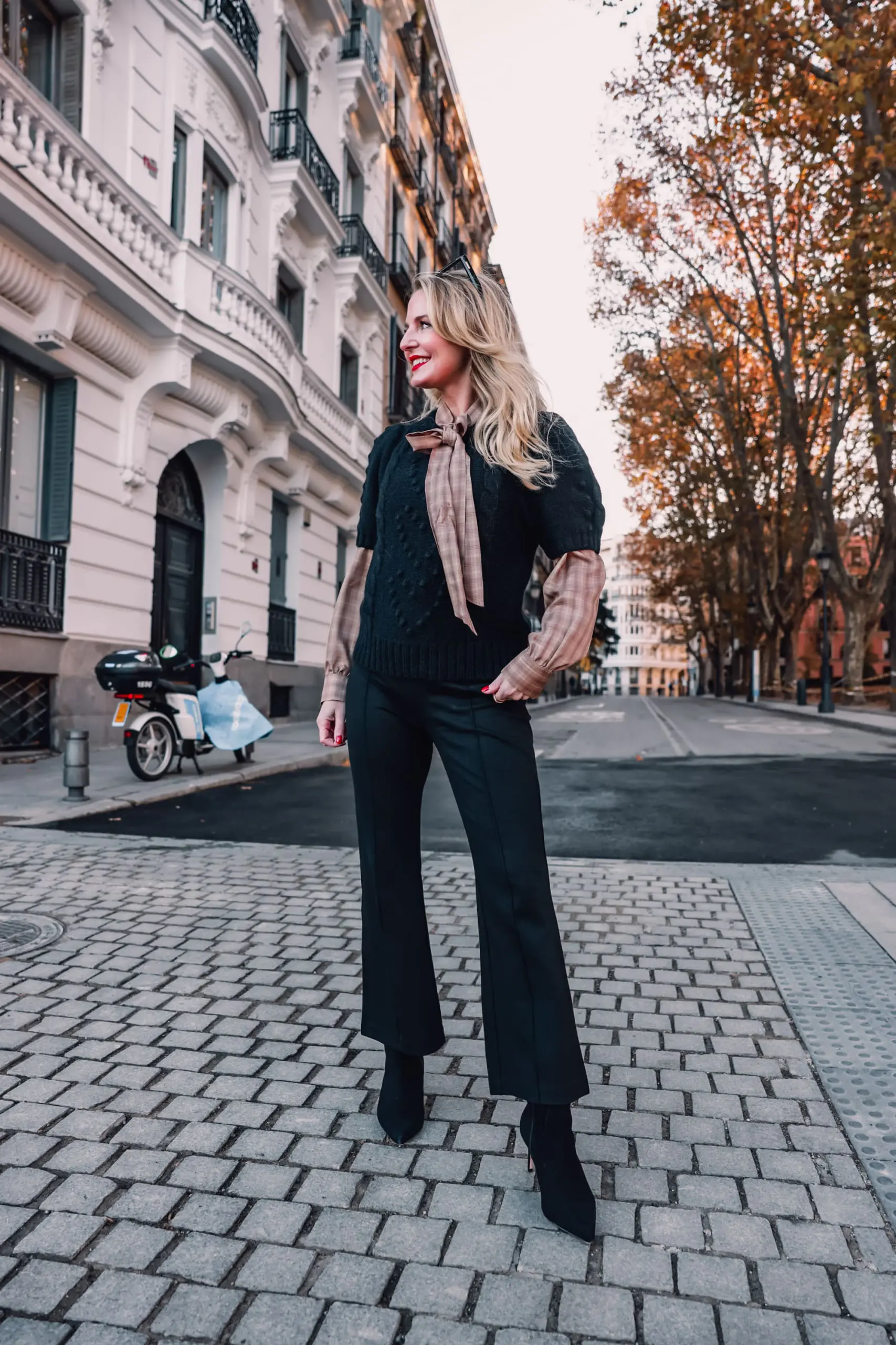 how to wear plaid, plaid, ways to wear plaid, plaid outfit, plaid over 40, erin busbee, & other stories check tie neck blouse, & other stories bobble and cable knit puff sleeve sweater, black & other stories flare pants, black schutz bette booties, madrid, spain