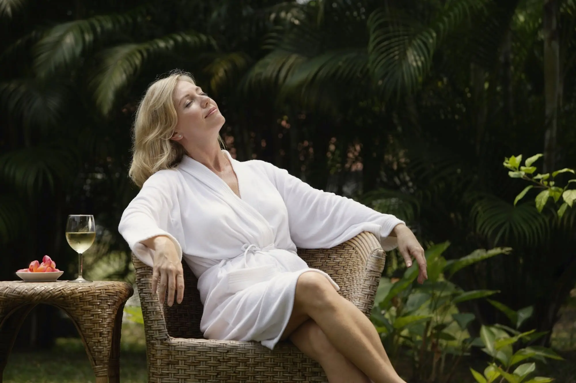 creative staycation ideas, woman over 40 relaxing outdoors in a bathrobe