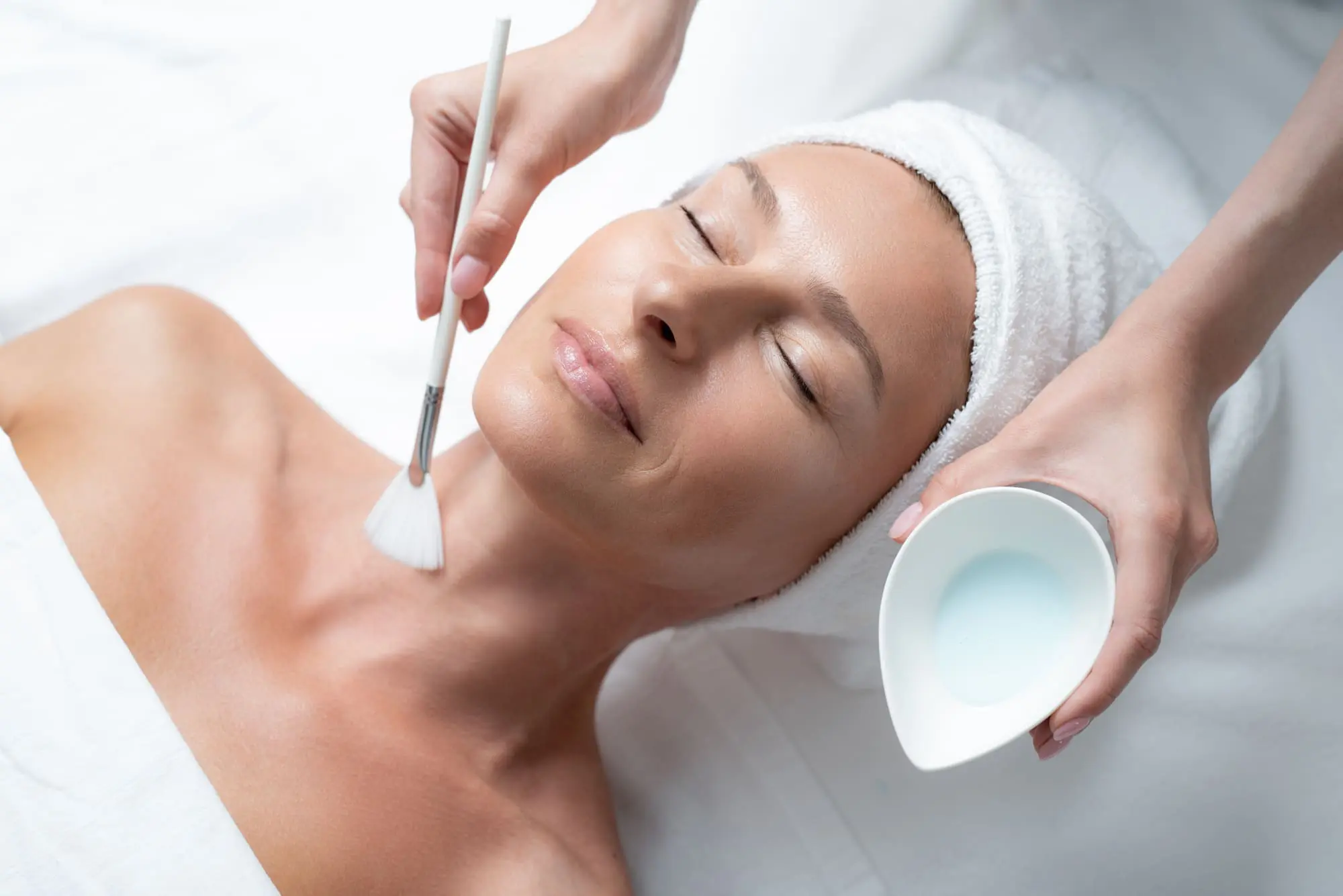 creative staycation ideas, woman over 40 relaxing enjoying a facial spa