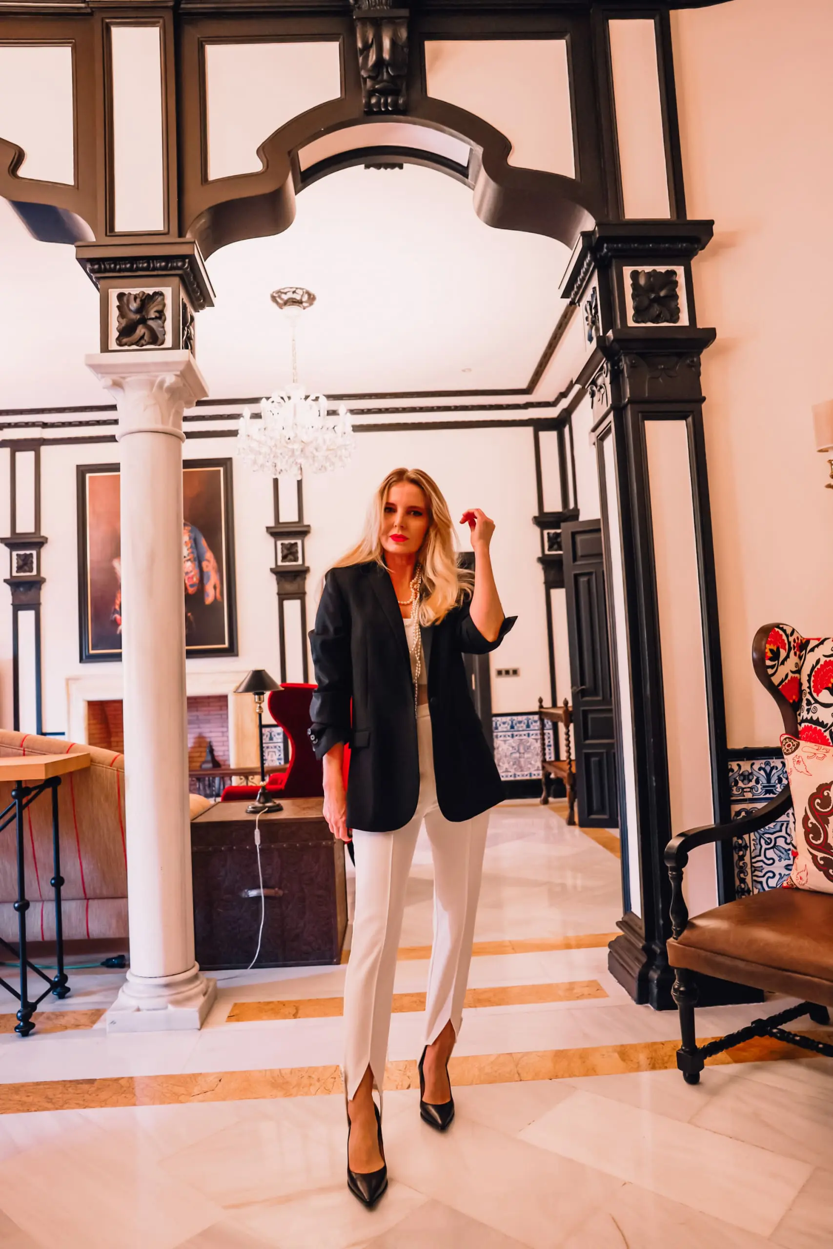 stirrup pants trend, stirrup trend, stirrup pants, stirrup leggings, stirrup tights, stirrup pants 80s, stirrup jeans, elisabetta frnachi white stirrup trousers, black mango boyfriend blazer, white cami, black pointed toe pumps, multi-strand pearl chanel necklace, erin bsubee, sevilla, spain, Hotel Alfonso XIII