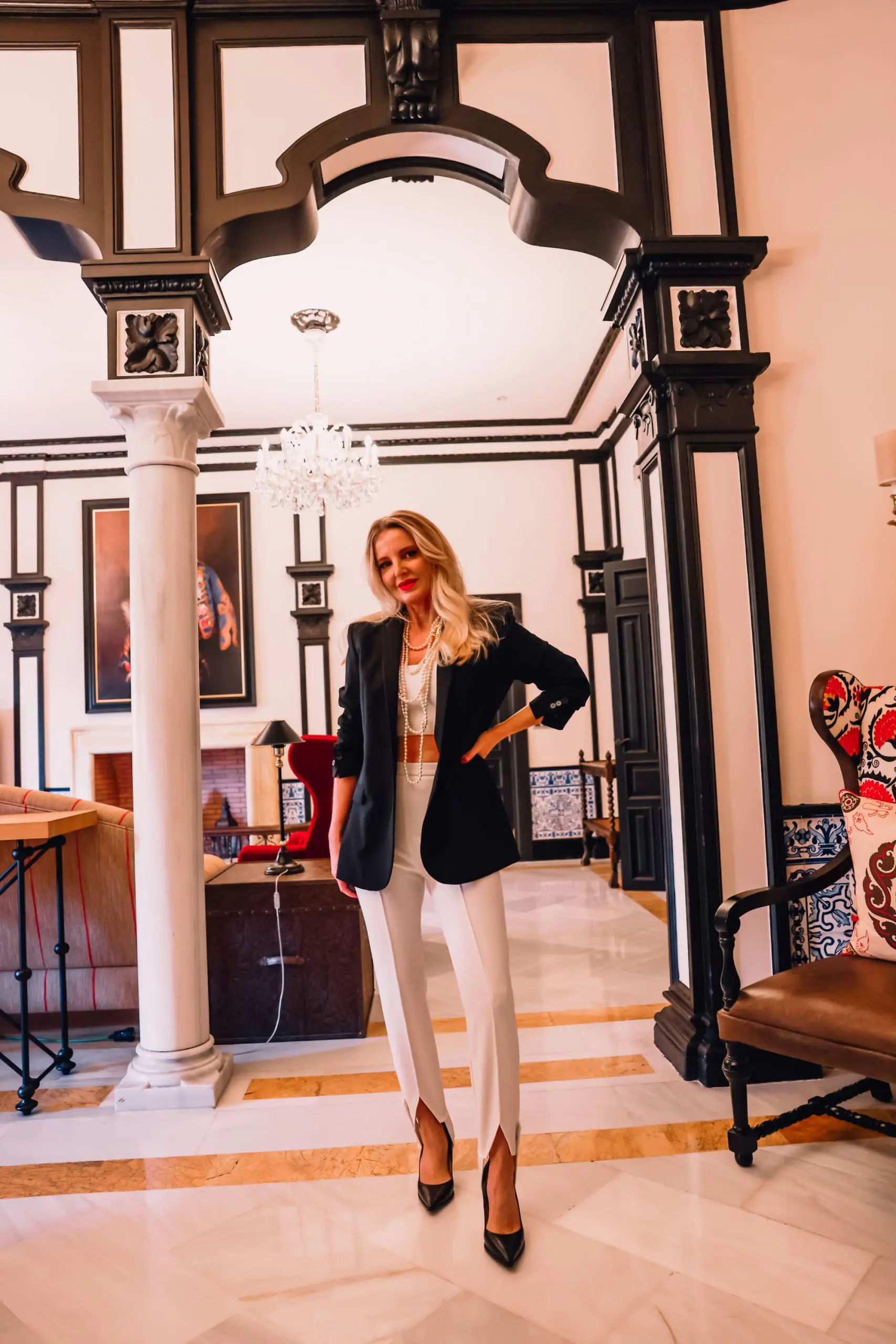 stirrup pants trend, stirrup trend, stirrup pants, stirrup leggings, stirrup tights, stirrup pants 80s, stirrup jeans, elisabetta frnachi white stirrup trousers, black mango boyfriend blazer, white cami, black pointed toe pumps, multi-strand pearl chanel necklace, erin bsubee, sevilla, spain, Hotel Alfonso XIII