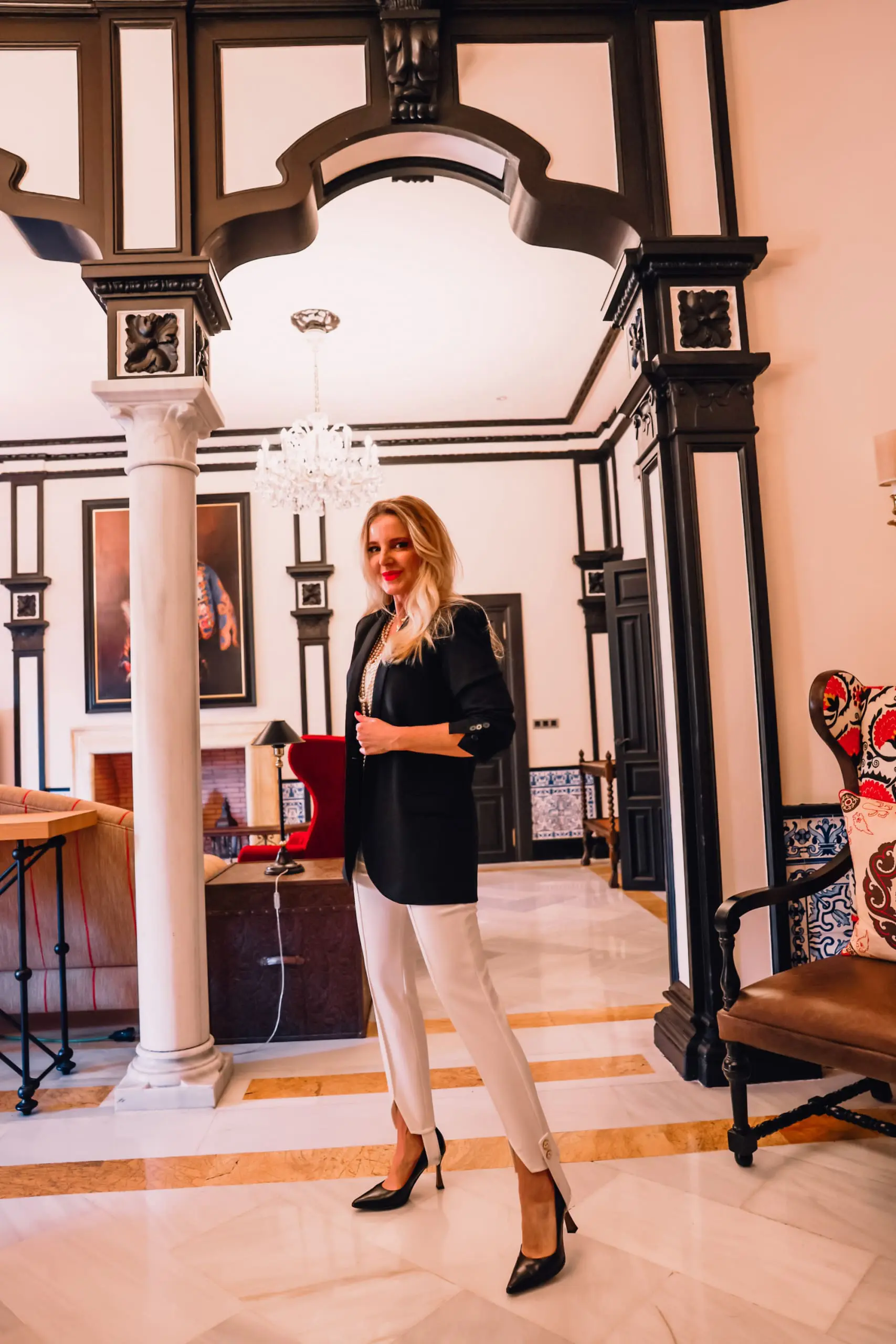 stirrup pants trend, stirrup trend, stirrup pants, stirrup leggings, stirrup tights, stirrup pants 80s, stirrup jeans, elisabetta frnachi white stirrup trousers, black mango boyfriend blazer, white cami, black pointed toe pumps, multi-strand pearl chanel necklace, erin bsubee, sevilla, spain, Hotel Alfonso XIII