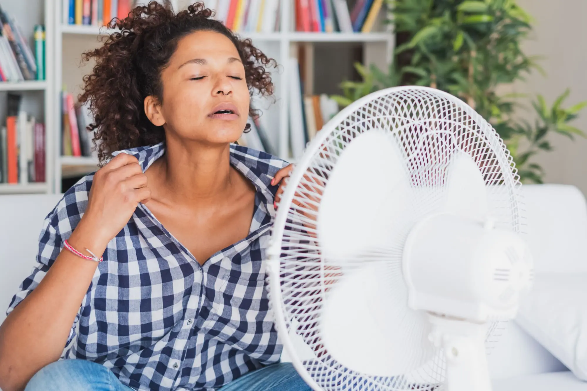 things no one tells you about menopause, menopause questions, menopause women over 40, Black woman feeling hot and trying to refresh, 