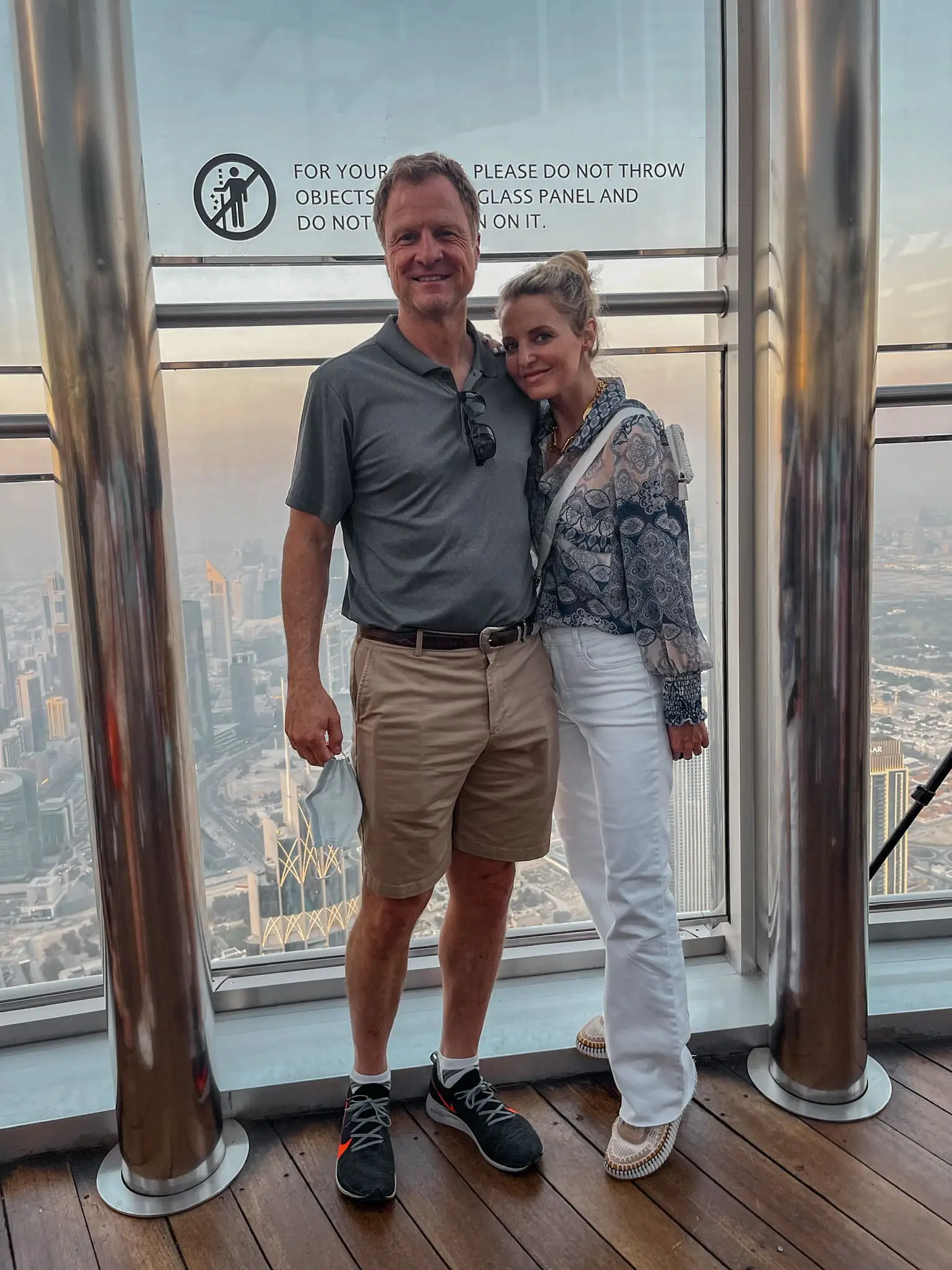 planning a trip to the middle east, where to go in the middle east, how to plan a trip to the middle east, dubai, united arab emirates, UAE, tallest building in the world, Burj Khalifa, visiting Burj Khalifa, views from Burj Khalifa, erin busbee, busbee style, busbee family travels, misa blue printed blouse, chloe sneakers, white prada raffia bag, kut from the kloth white jeans