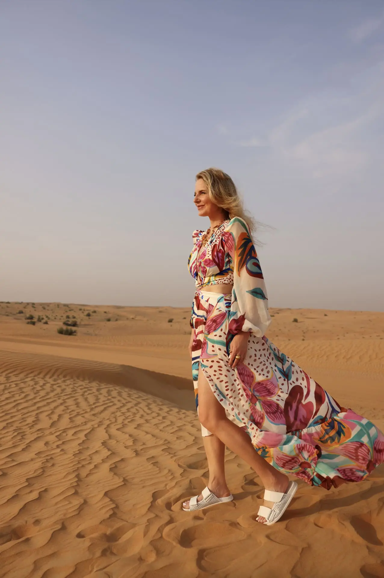 how to dress in middle east, womens dress code in middle east, middle eastern dress female, how to blend in in the middle east, shoes to wear in middle east, what to wear in middle east, how to look stylish in middle east, erin busbee, busbee style, patbo dress, headscarf, paco rabbane chunky necklace, mercedes castillo white slide sandals, riding camels in desert